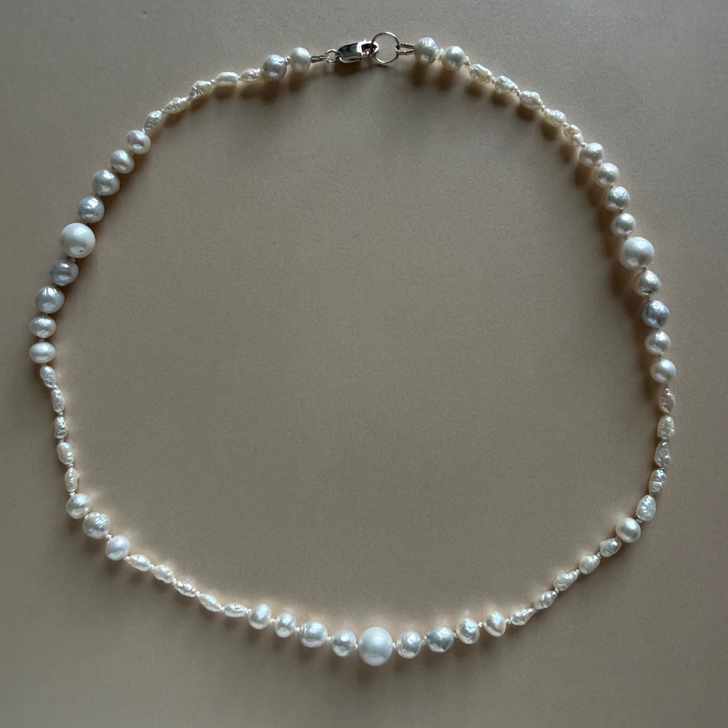 Pearl necklace on a beige background