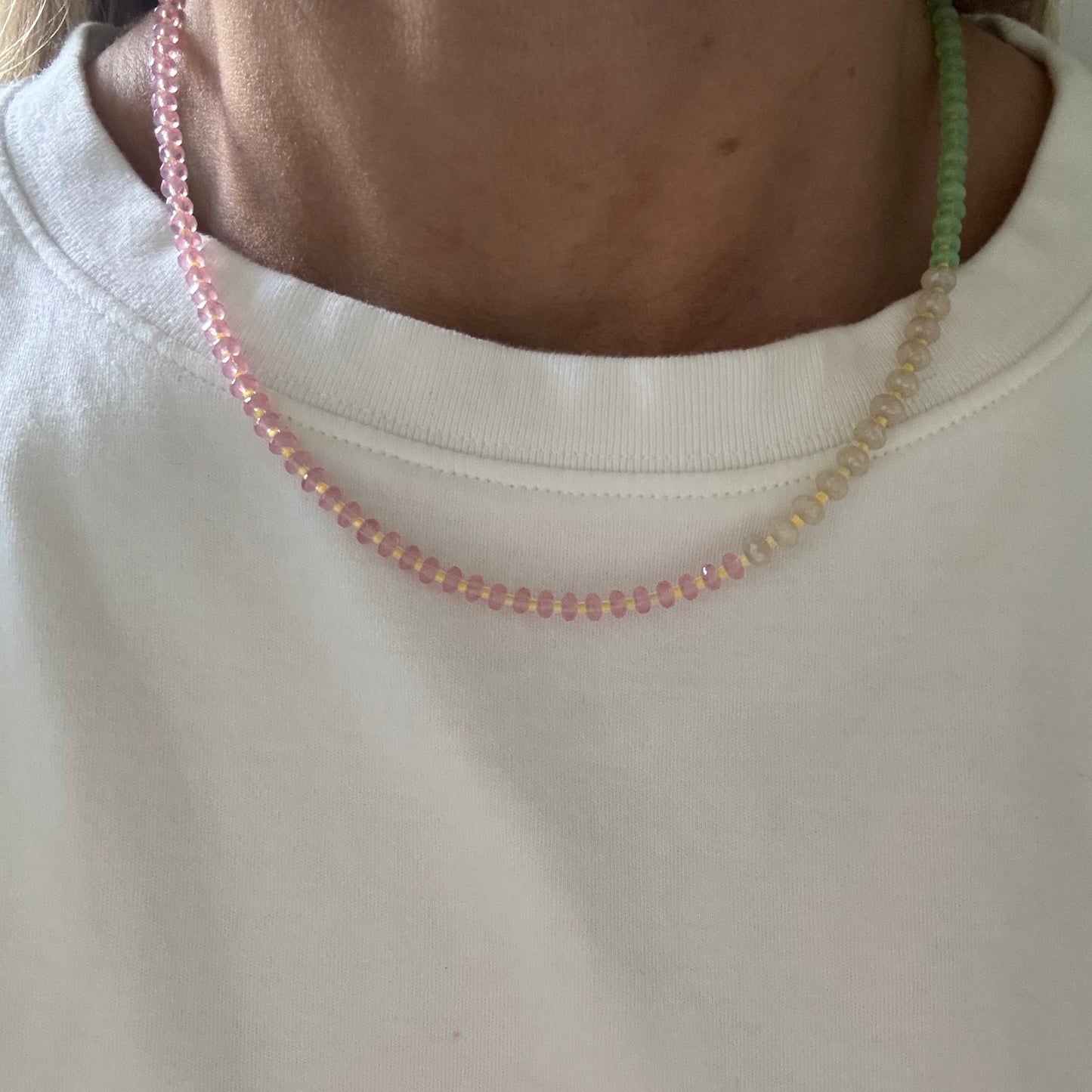 Close-up of a person wearing a white sweatshirt with a zipper