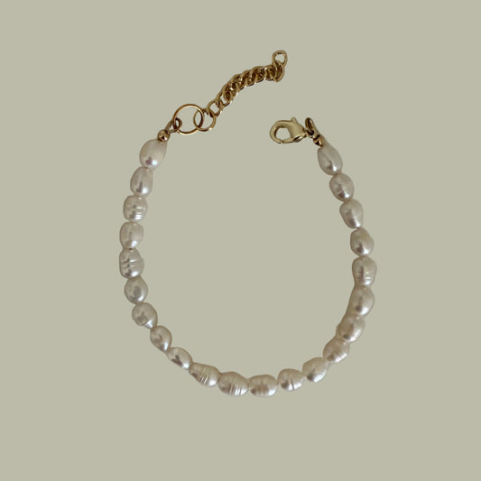 A bracelet with white freshwater pearls and a gold-filled closure.