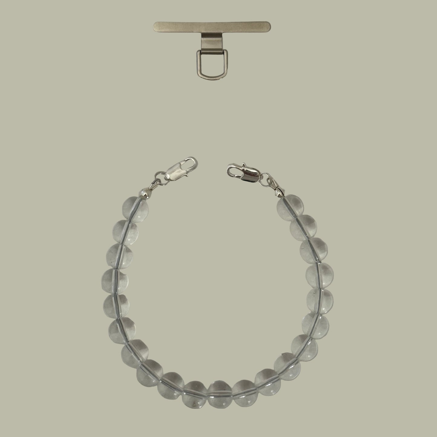 Smartphone chain with clear quartz beads, a silver clasp on a gray background.