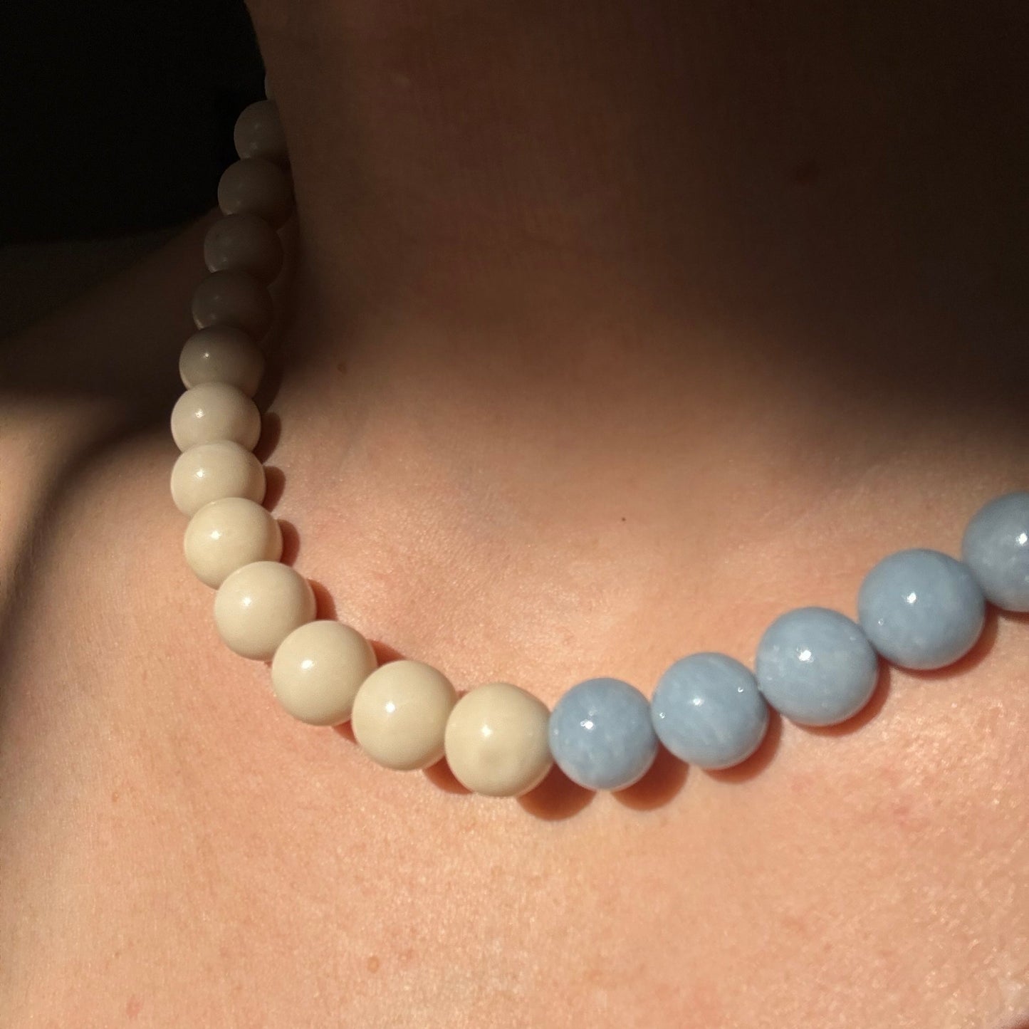 Close-up of a beaded necklace on a person's neck