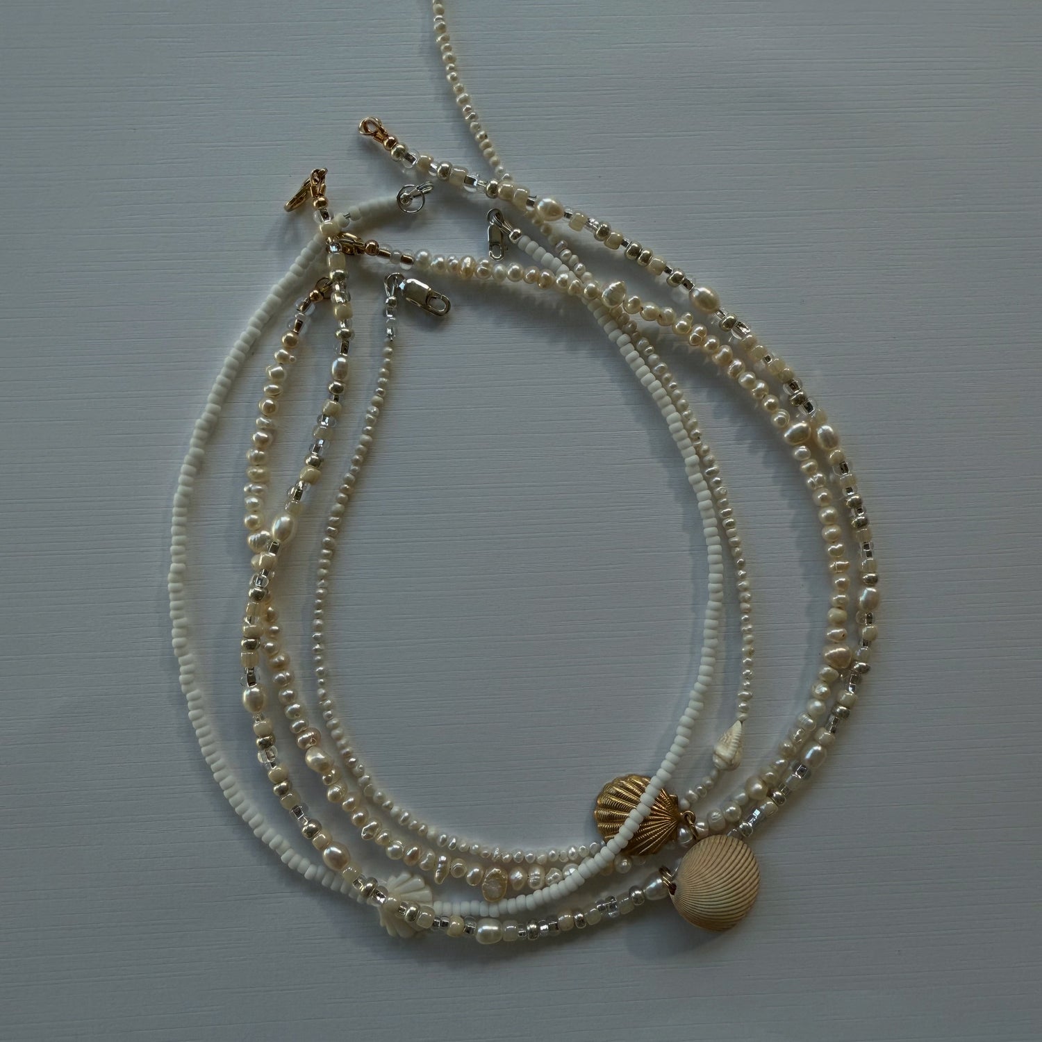 Set of beaded necklaces on a light gray background