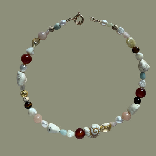 Beaded bracelet with various colored beads on a beige background