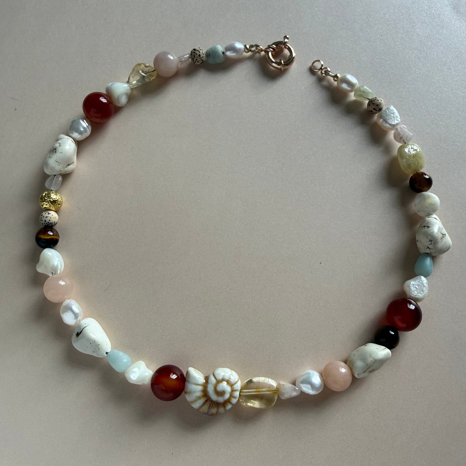 Beaded bracelet with various colored beads on a light background