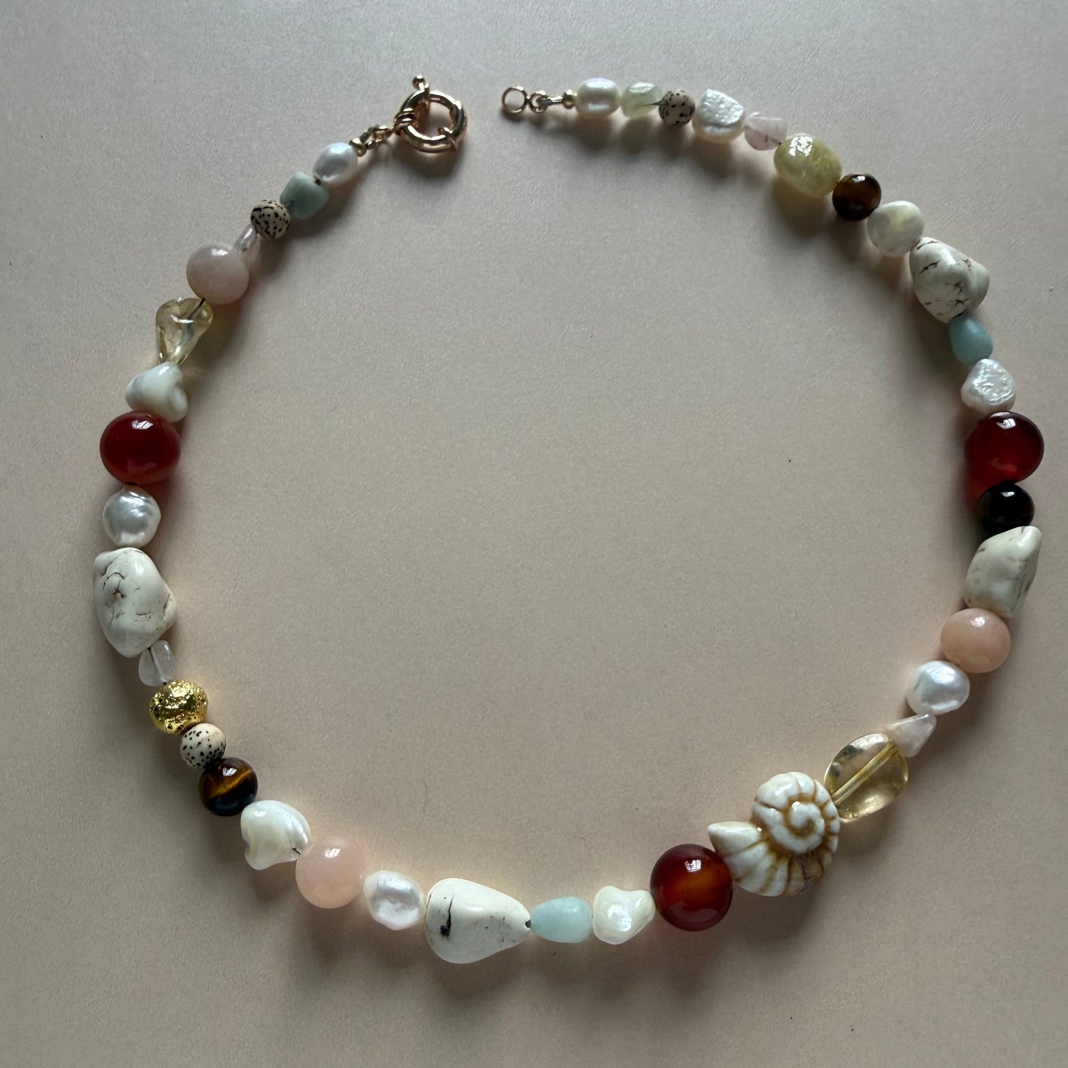 Beaded necklace with multicolored beads on a beige background
