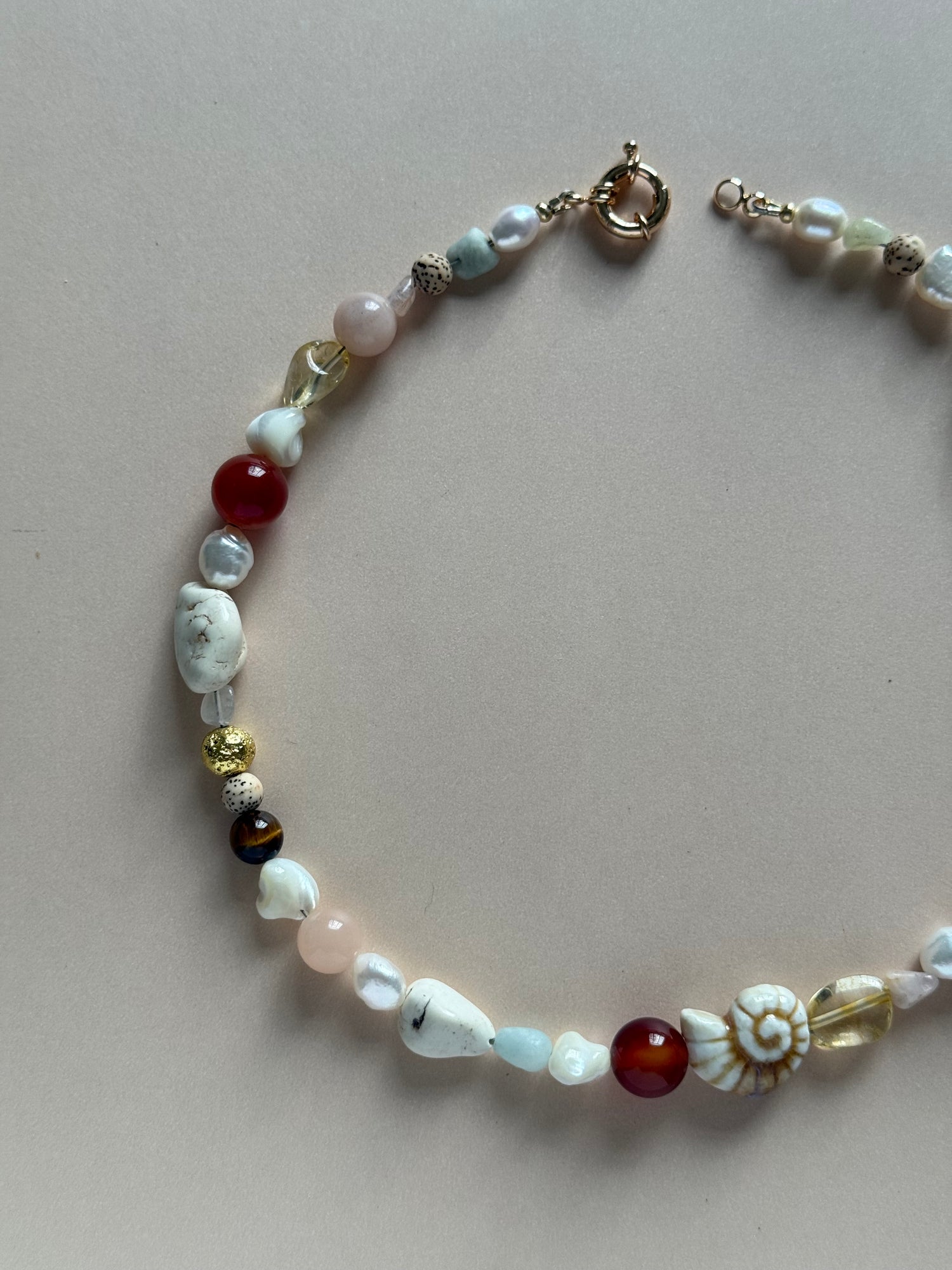 Beaded bracelet with various colored beads on a light gray background