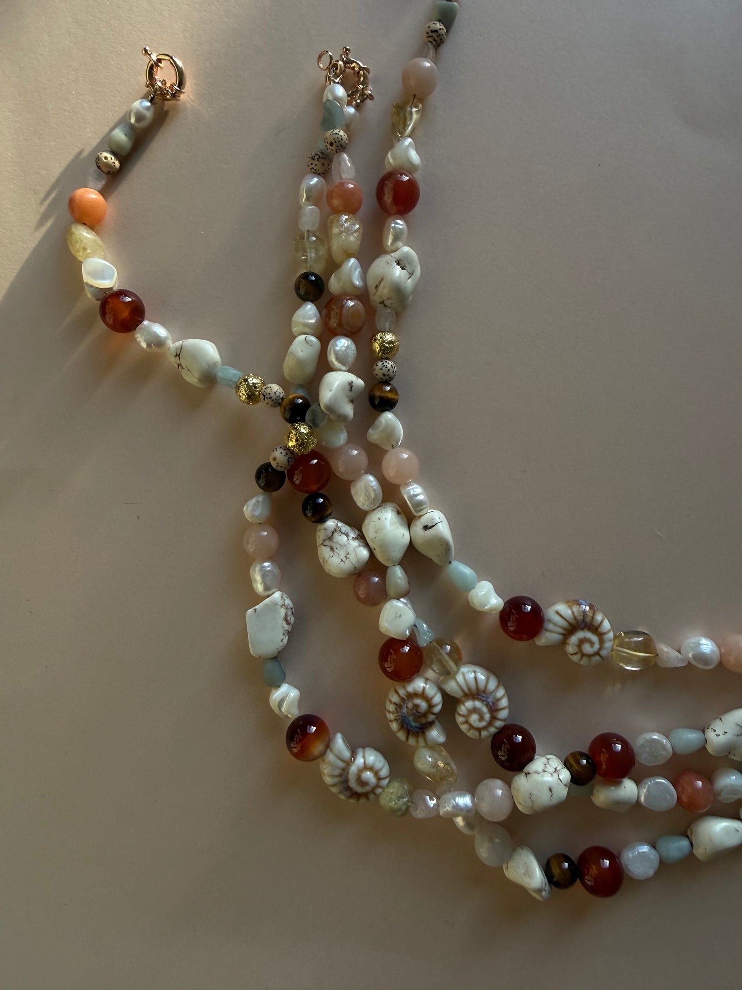 Multistrand beaded necklace on a light background