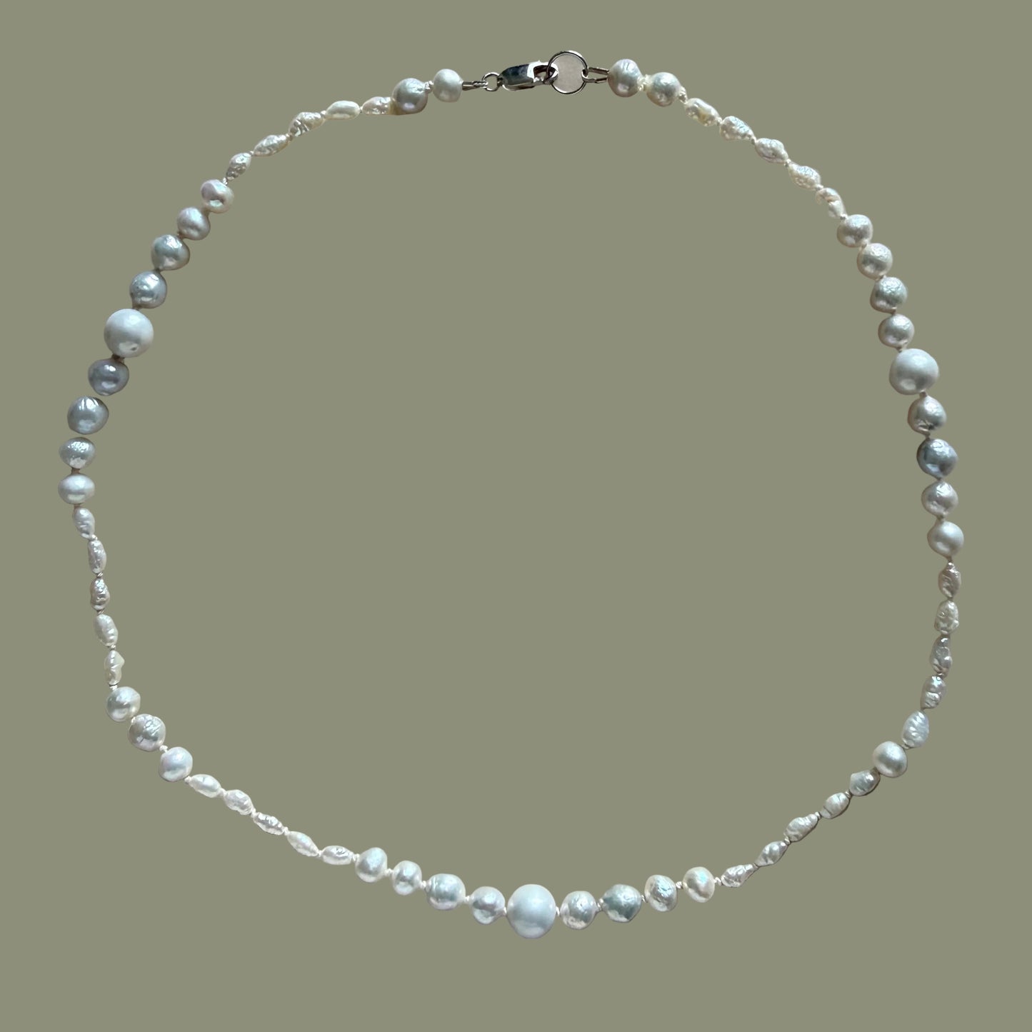 Pearl necklace on a beige background