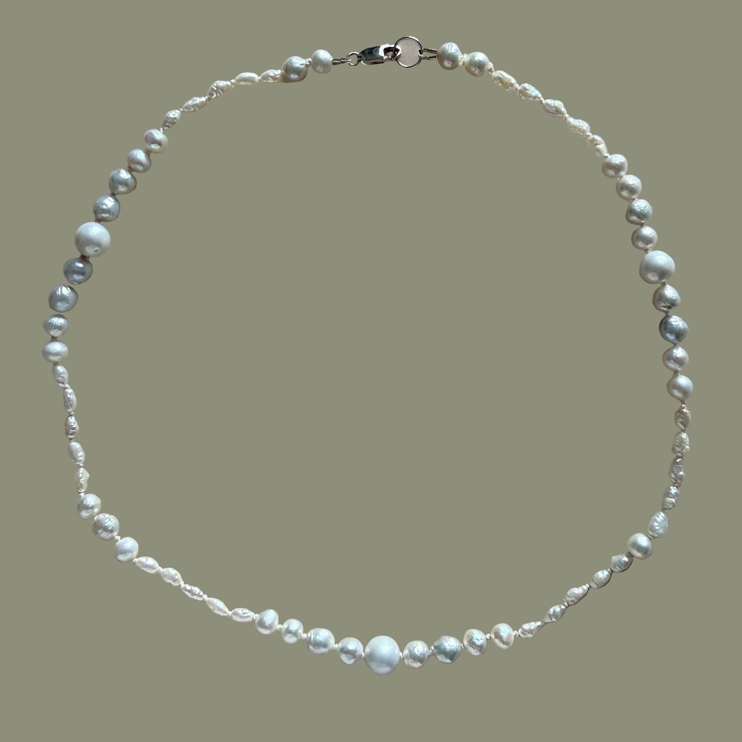 Pearl necklace on a beige background