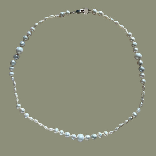 Pearl necklace on a beige background