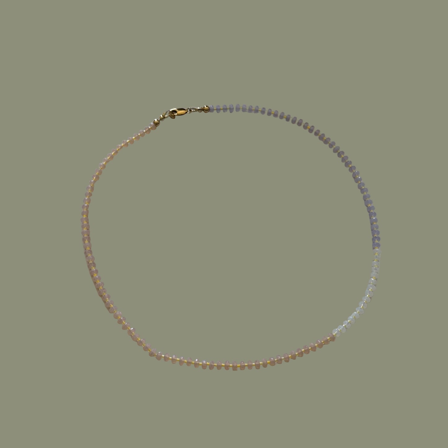 Necklace with small beads on a white surface