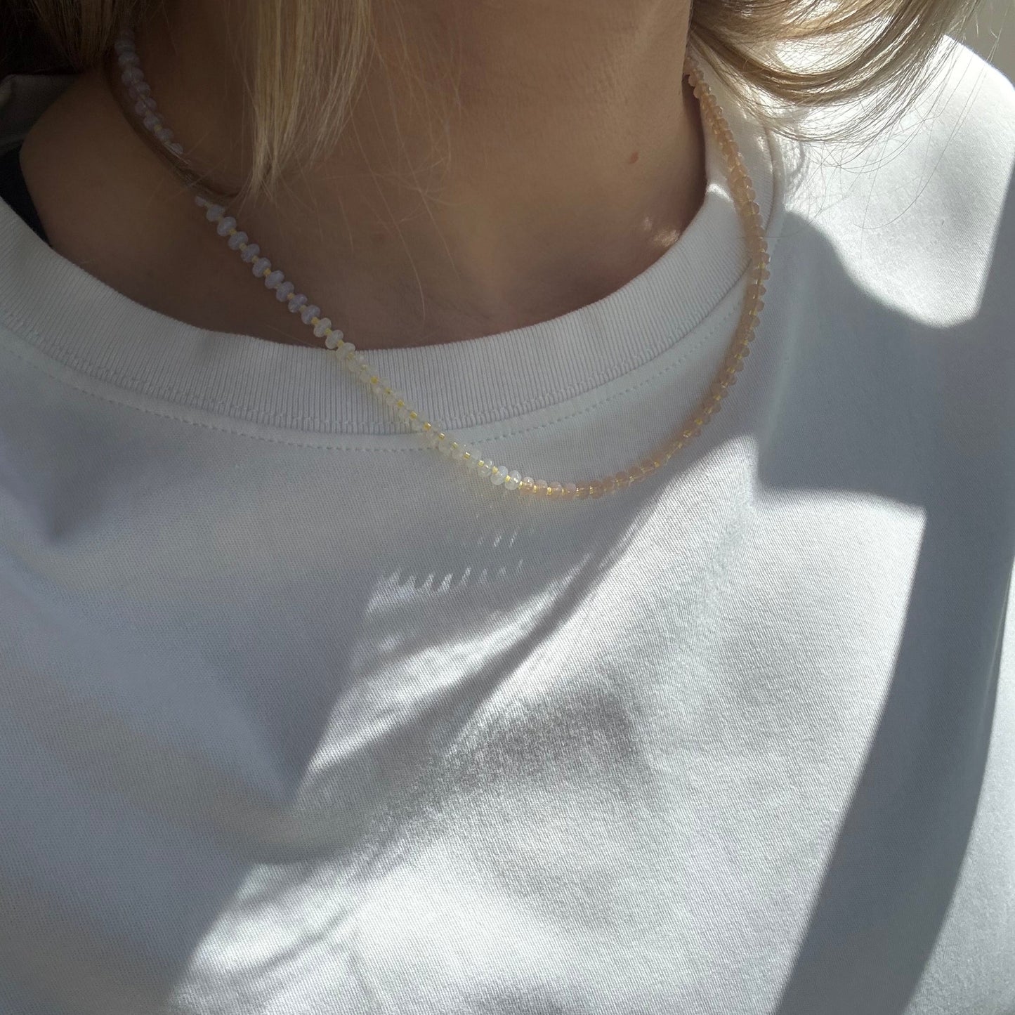 Person wearing a white shirt with a blurred background