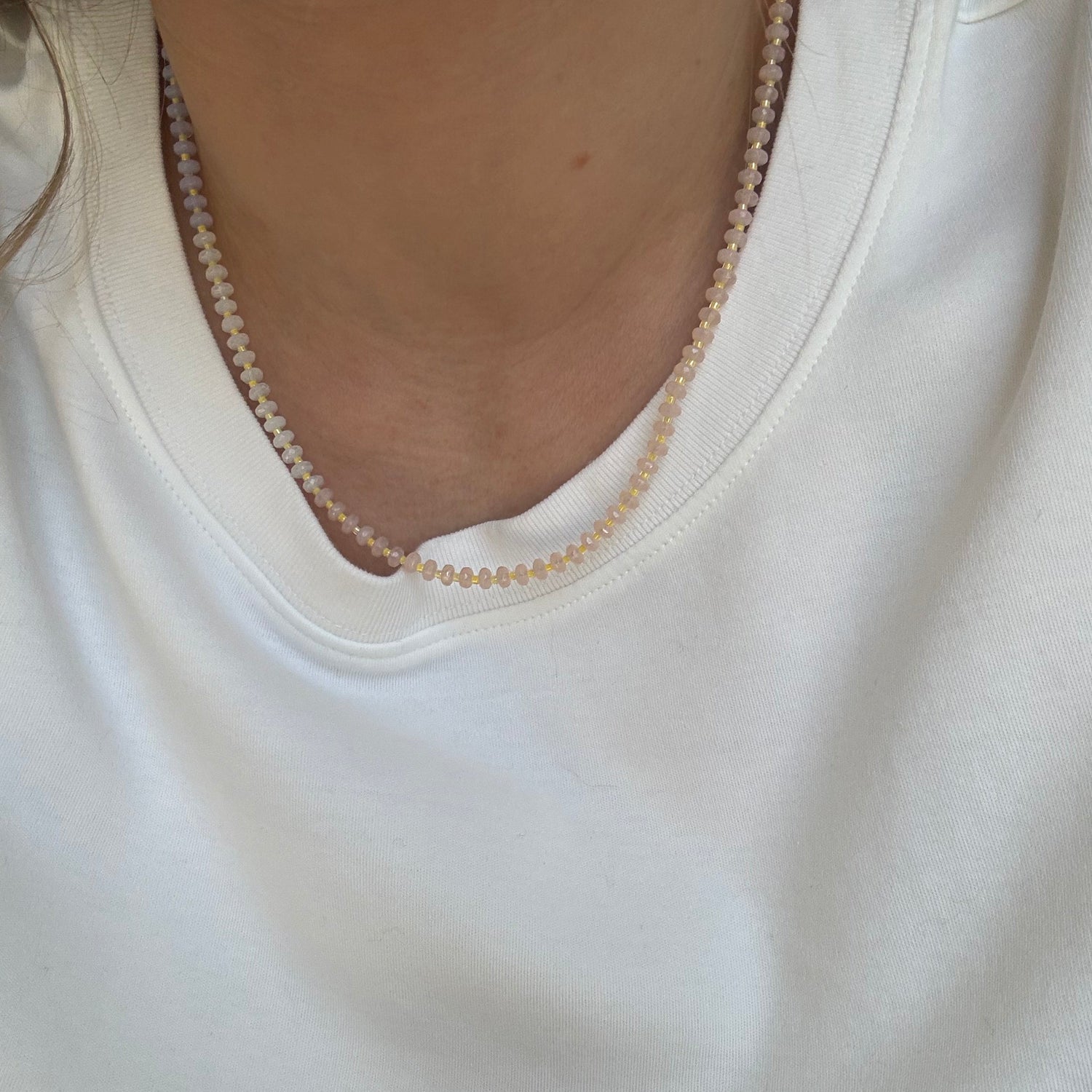 Close-up of a white garment with a visible seam and edge.