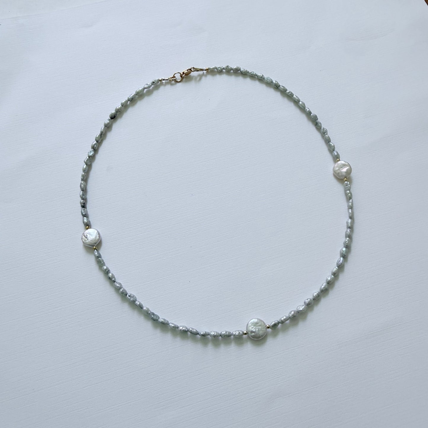 Necklace with small beads on a white surface