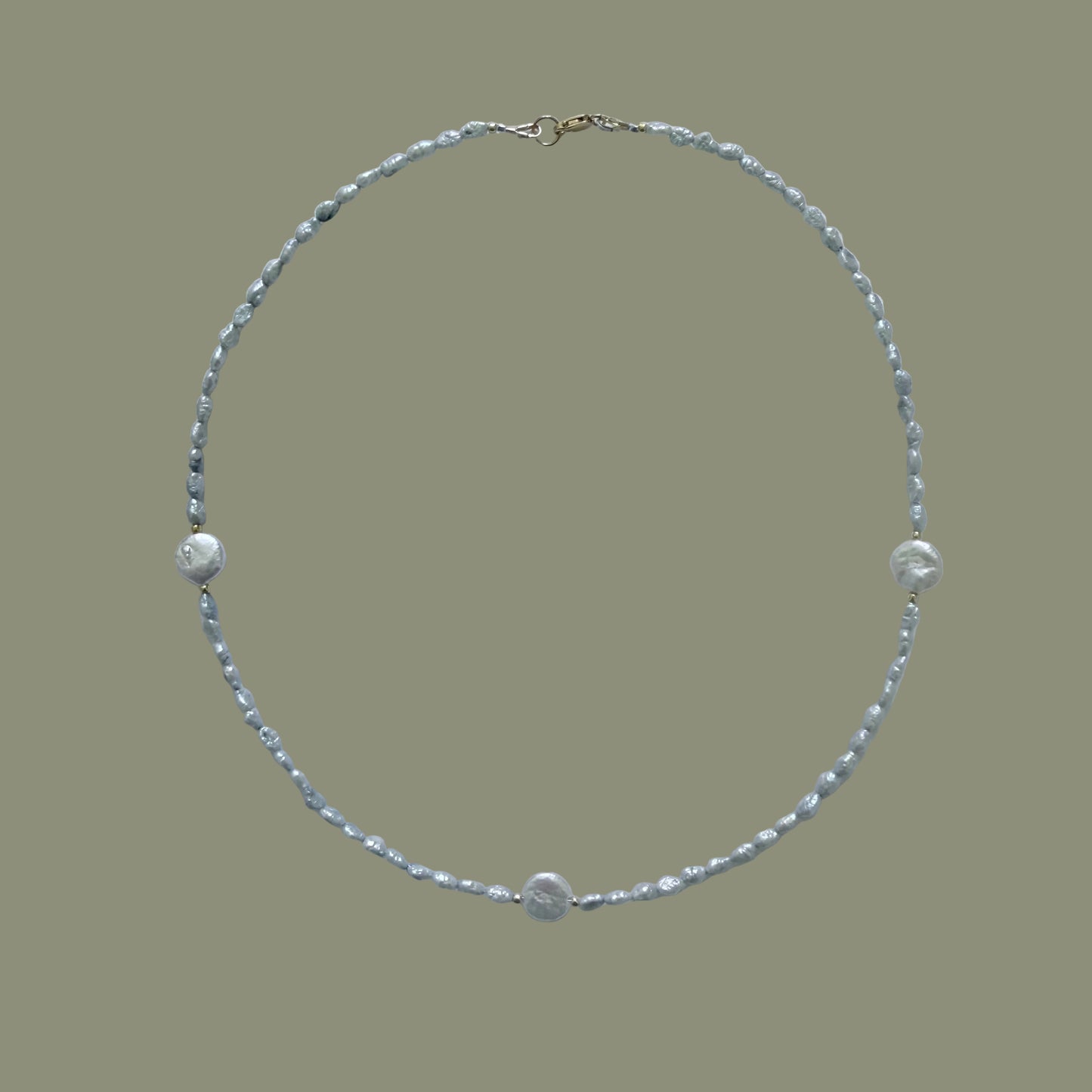 Pearl necklace on a light gray background