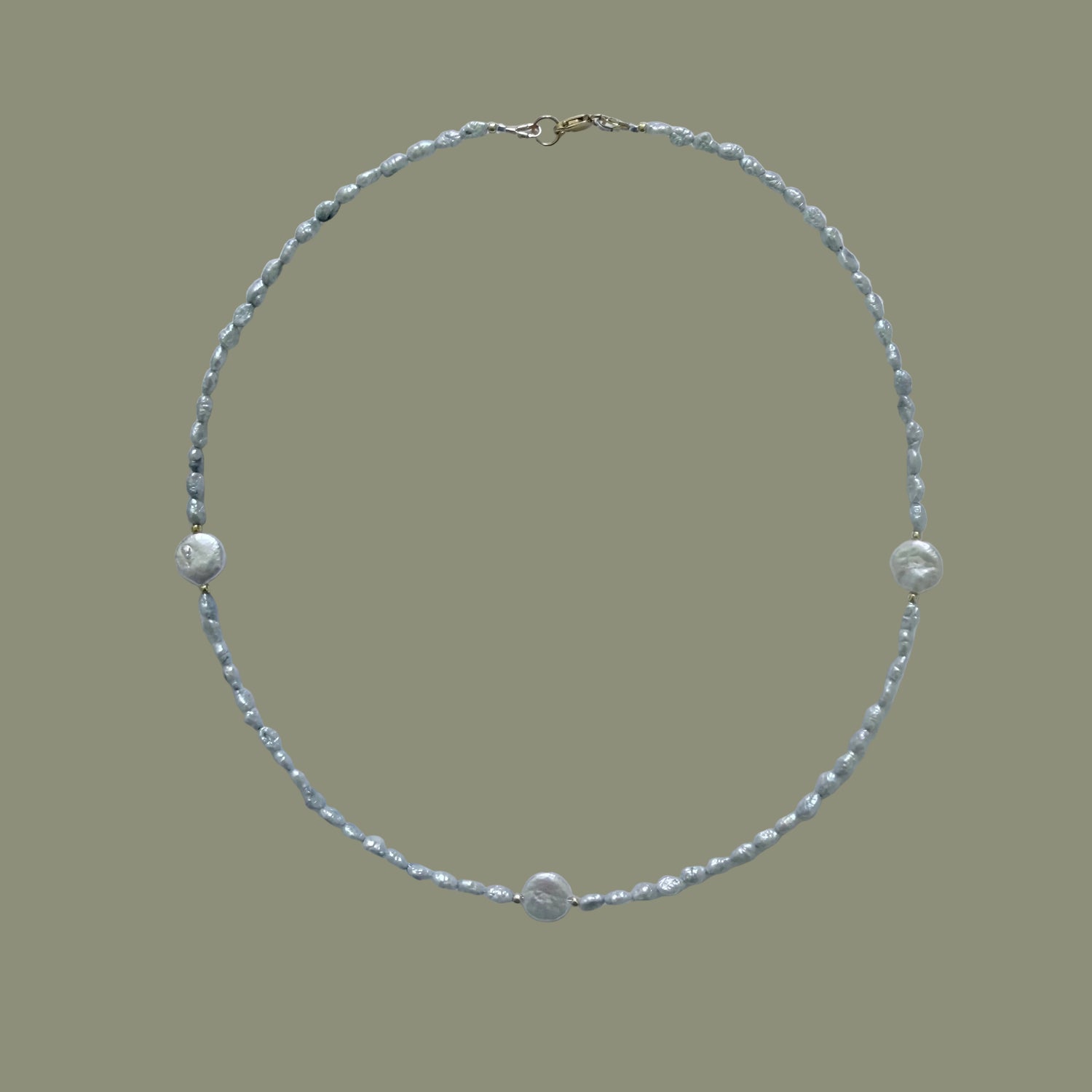 Pearl necklace on a light gray background