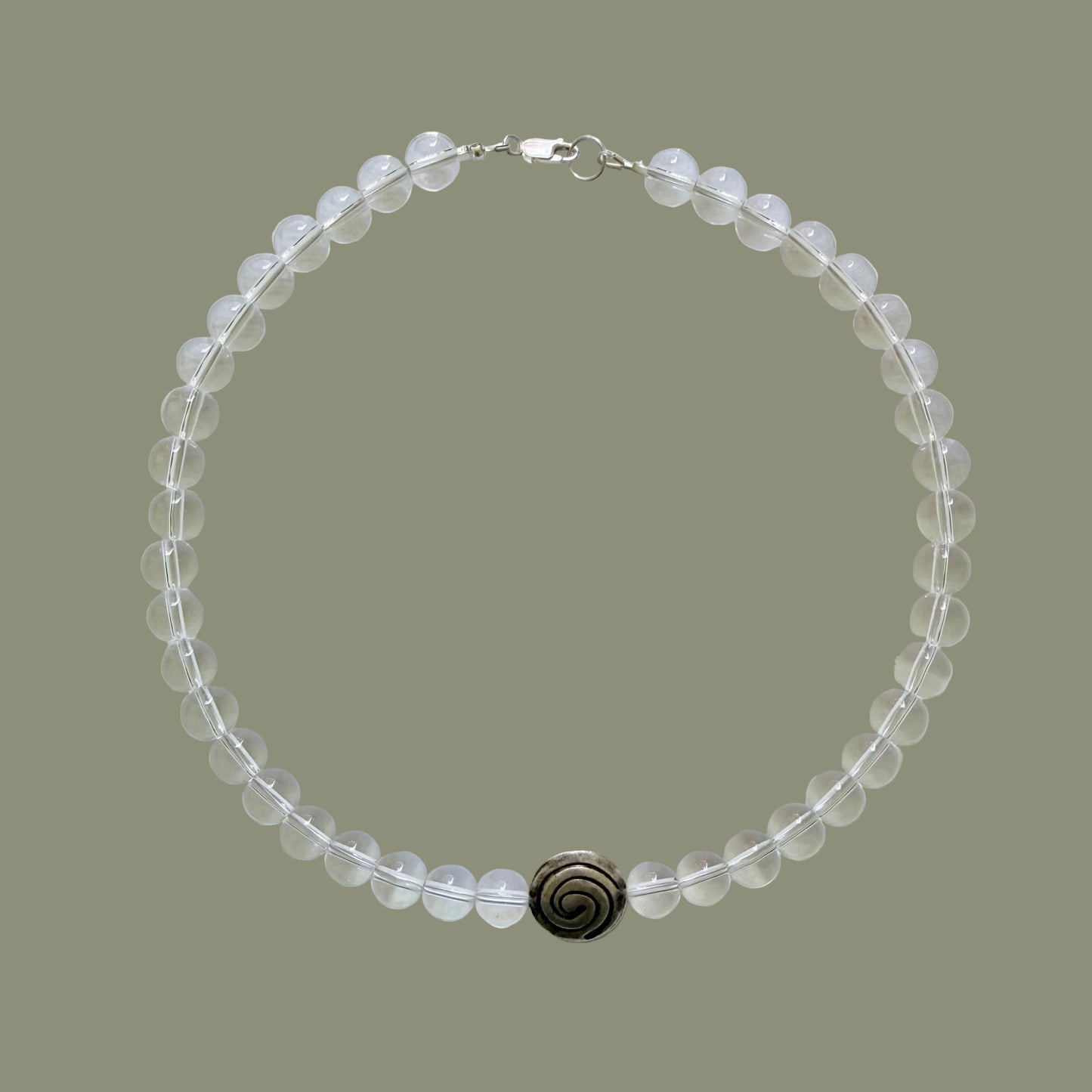 Beaded necklace with a dark clasp on a light gray background