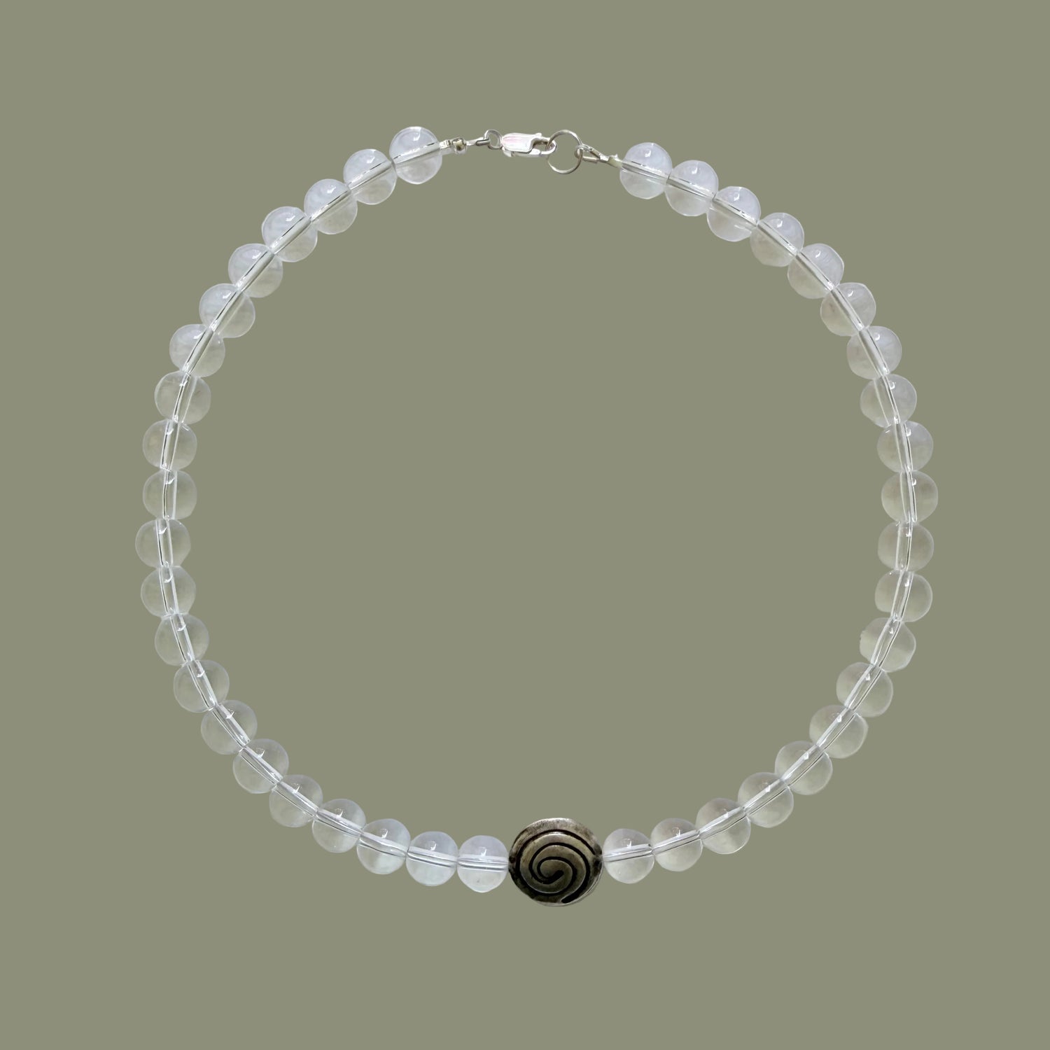 Beaded necklace with a dark clasp on a light gray background