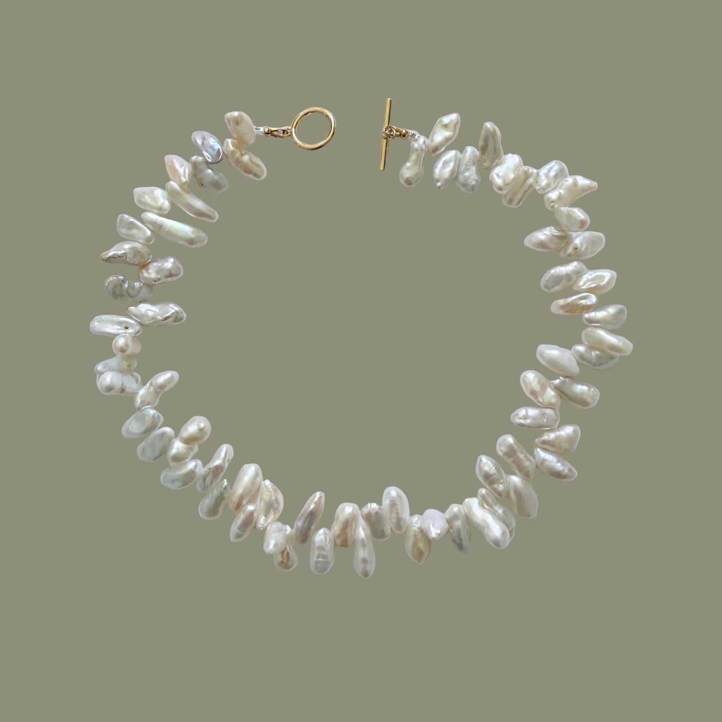 Pearl necklace with a gold clasp on a white background