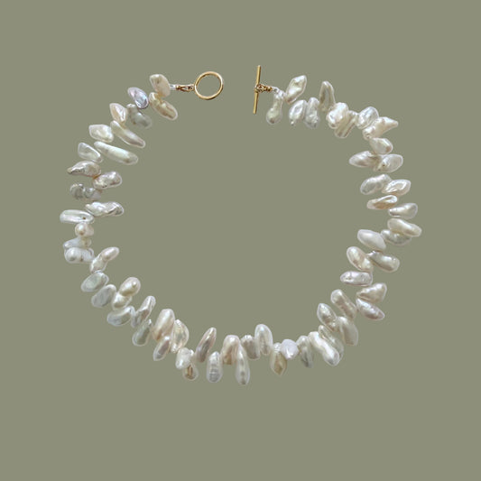 Pearl necklace with a gold clasp on a white background