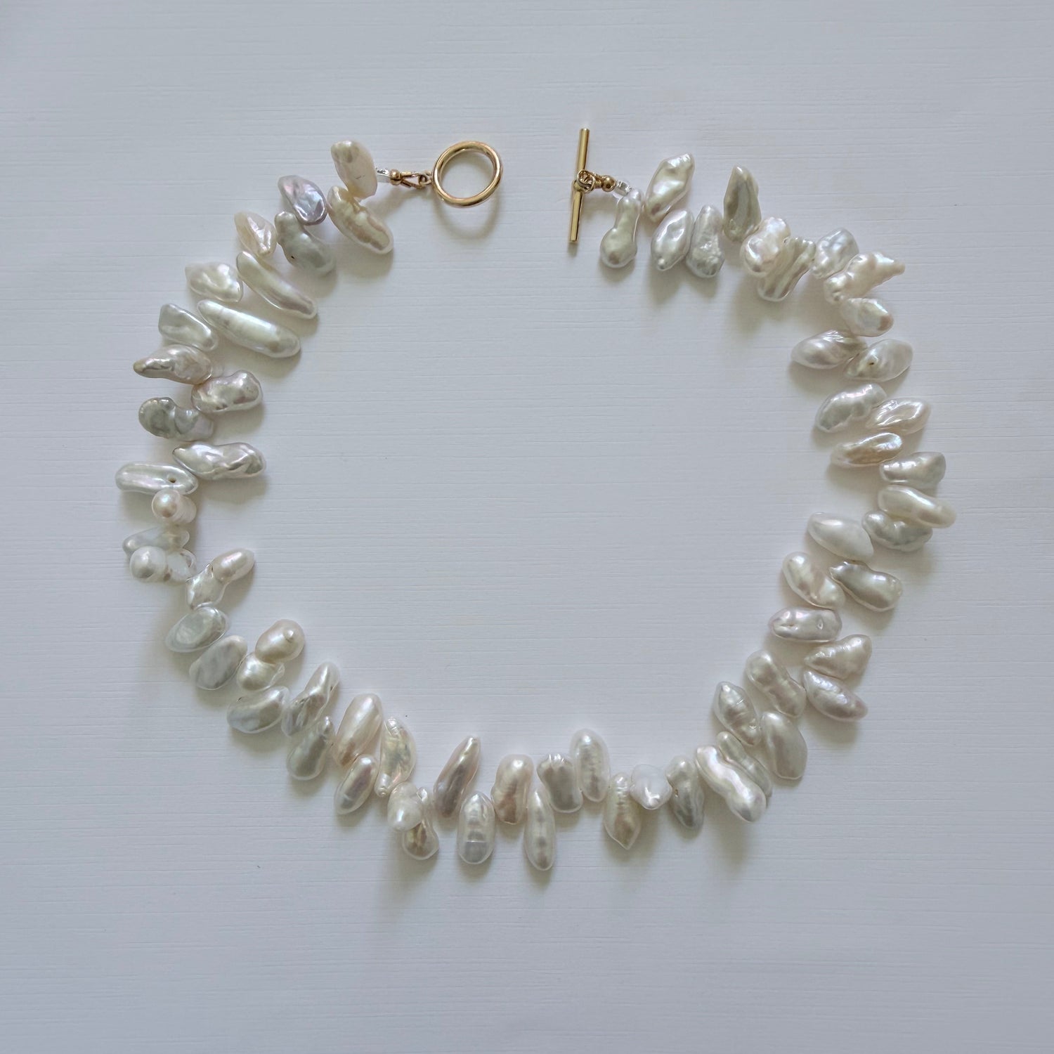 Pearl bracelet on a light gray background
