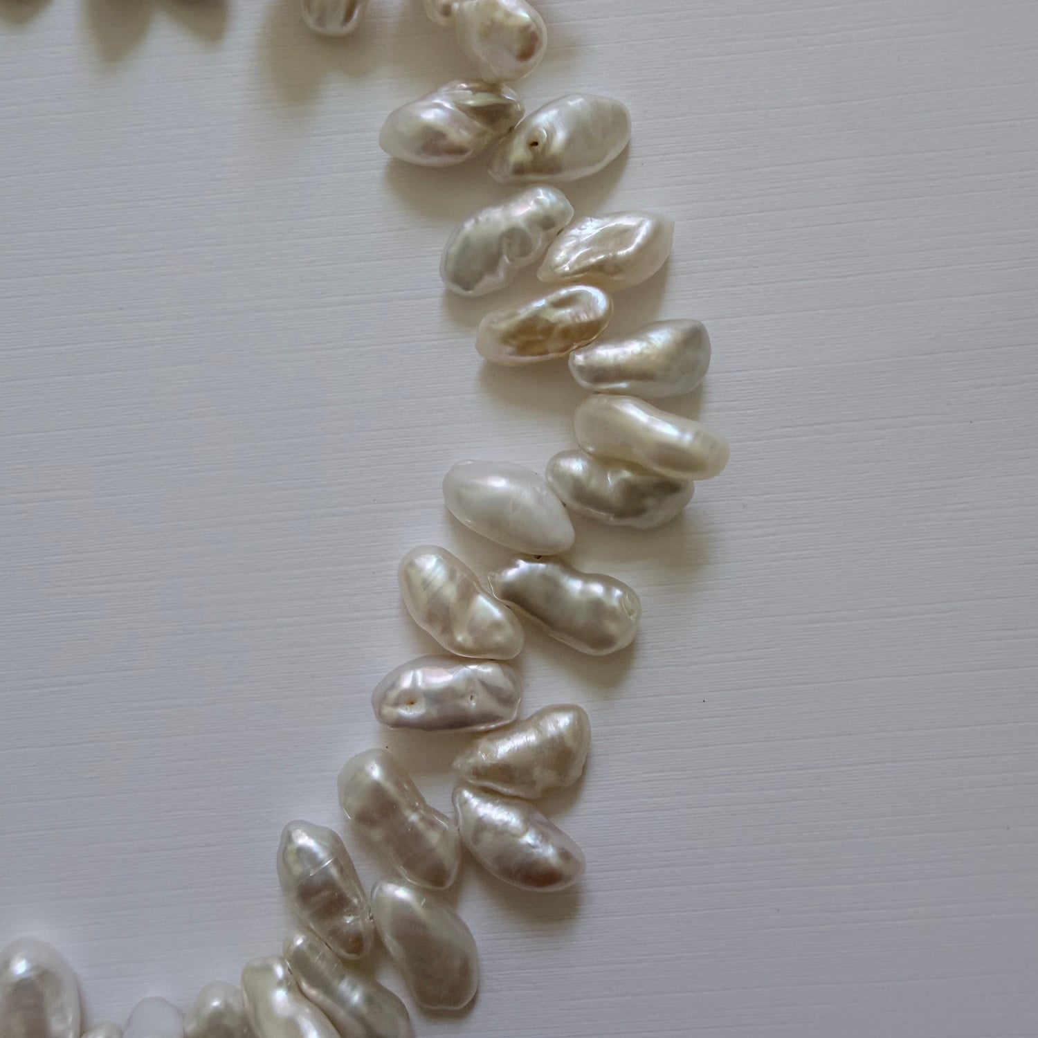 Pearl necklace on a light gray background
