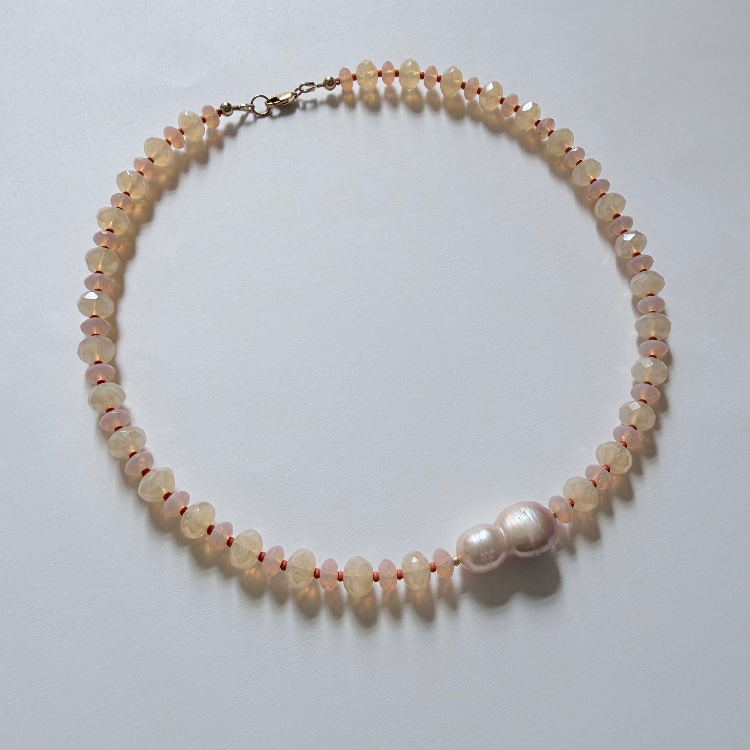 Pearl necklace on a white surface