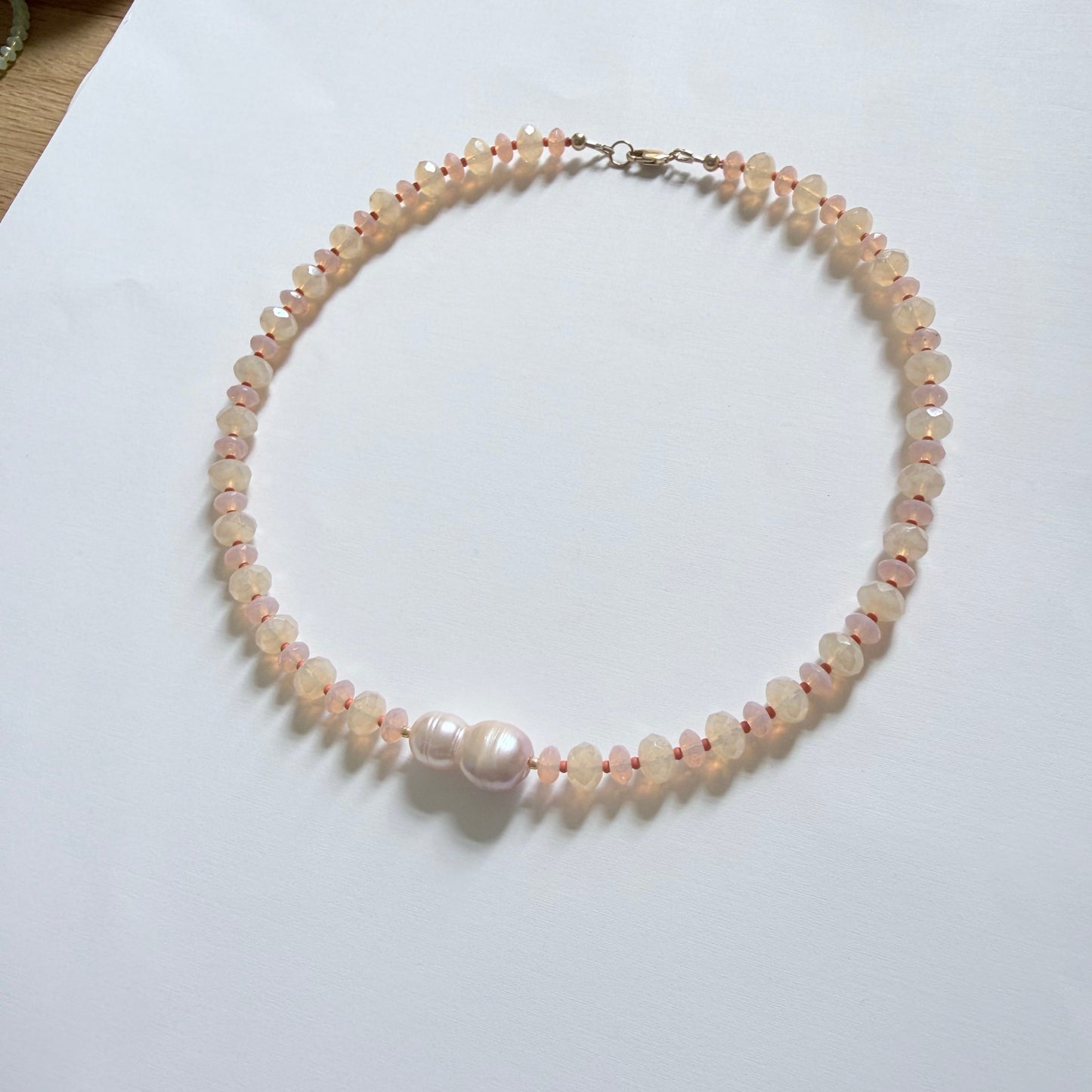 Pearl necklace on a white surface
