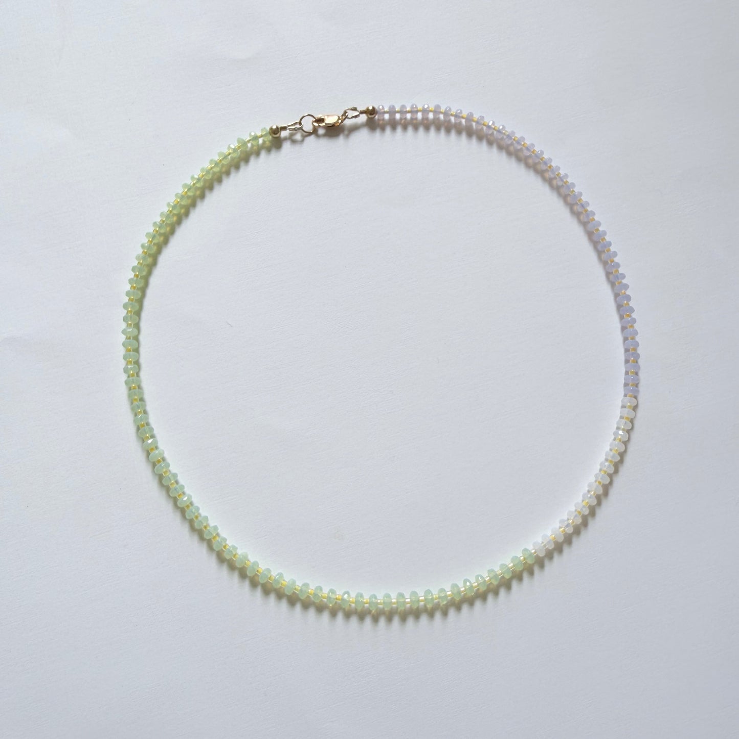 Necklace with green beads on a white background