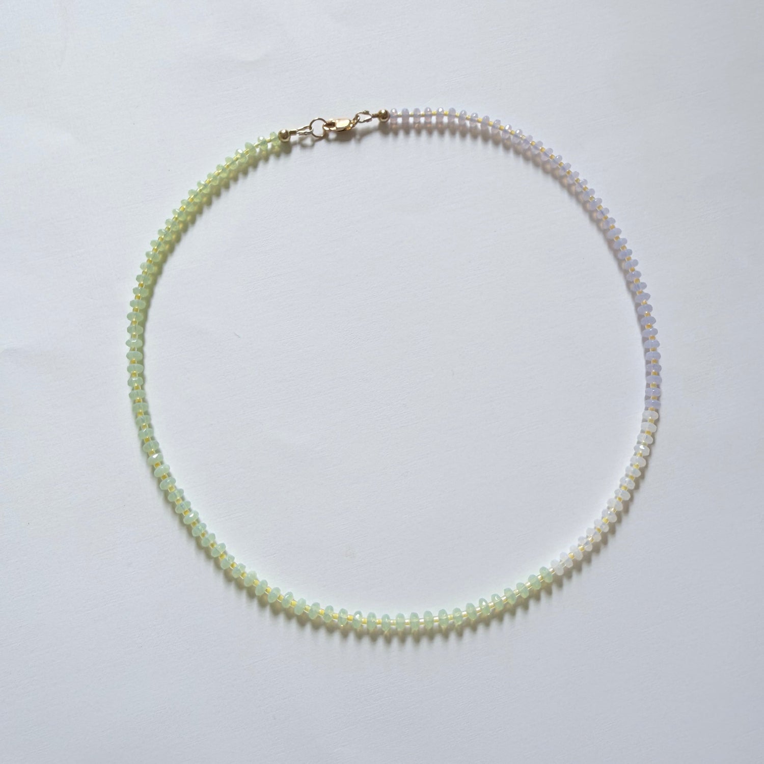 Necklace with green beads on a white background