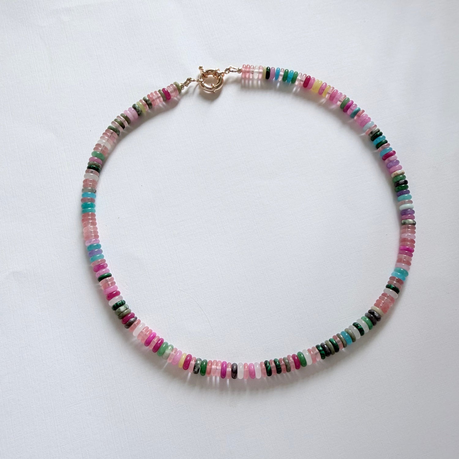 Multicolored beaded necklace on a white background