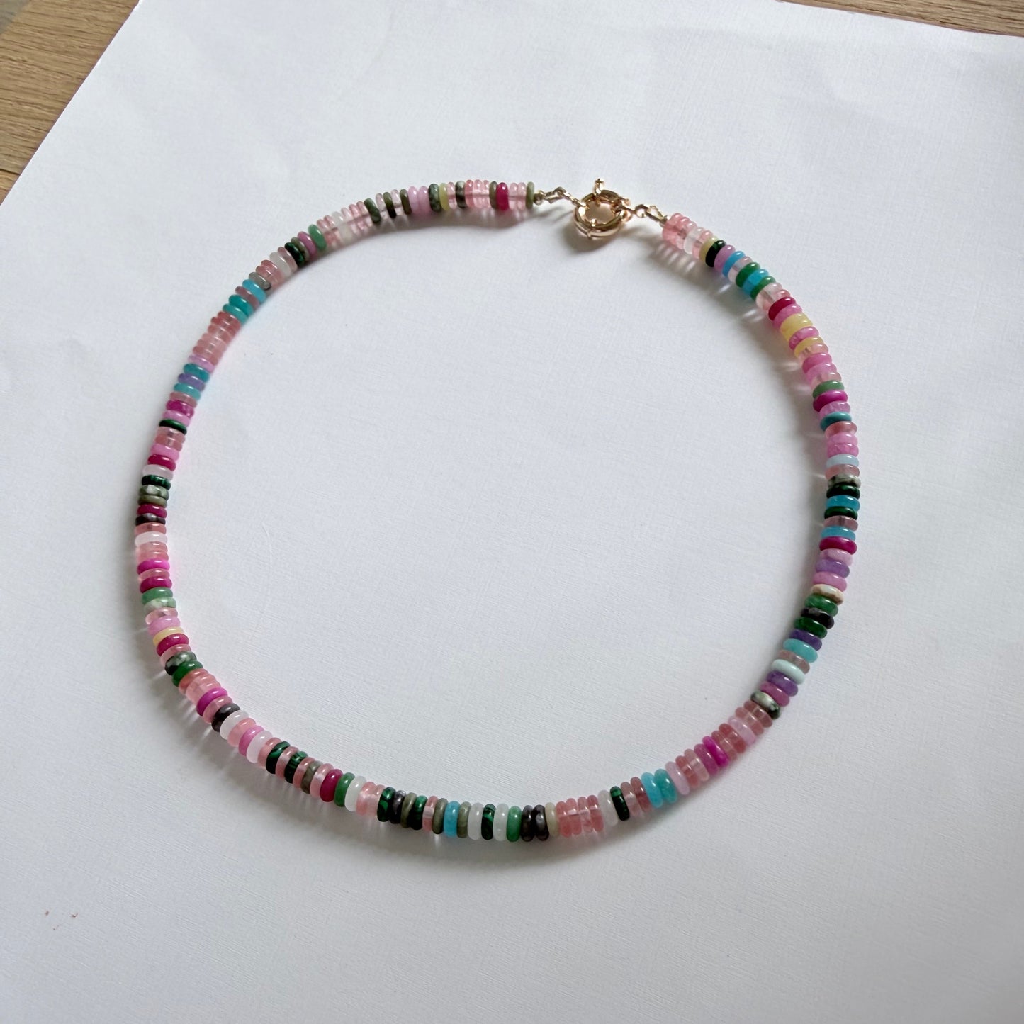 Multicolored beaded necklace on a white surface