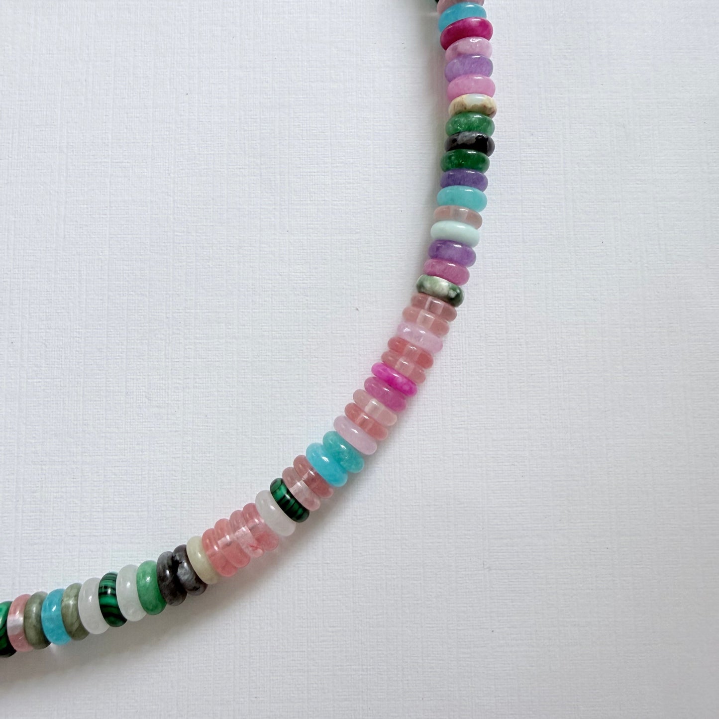 Colorful beaded necklace on a white background