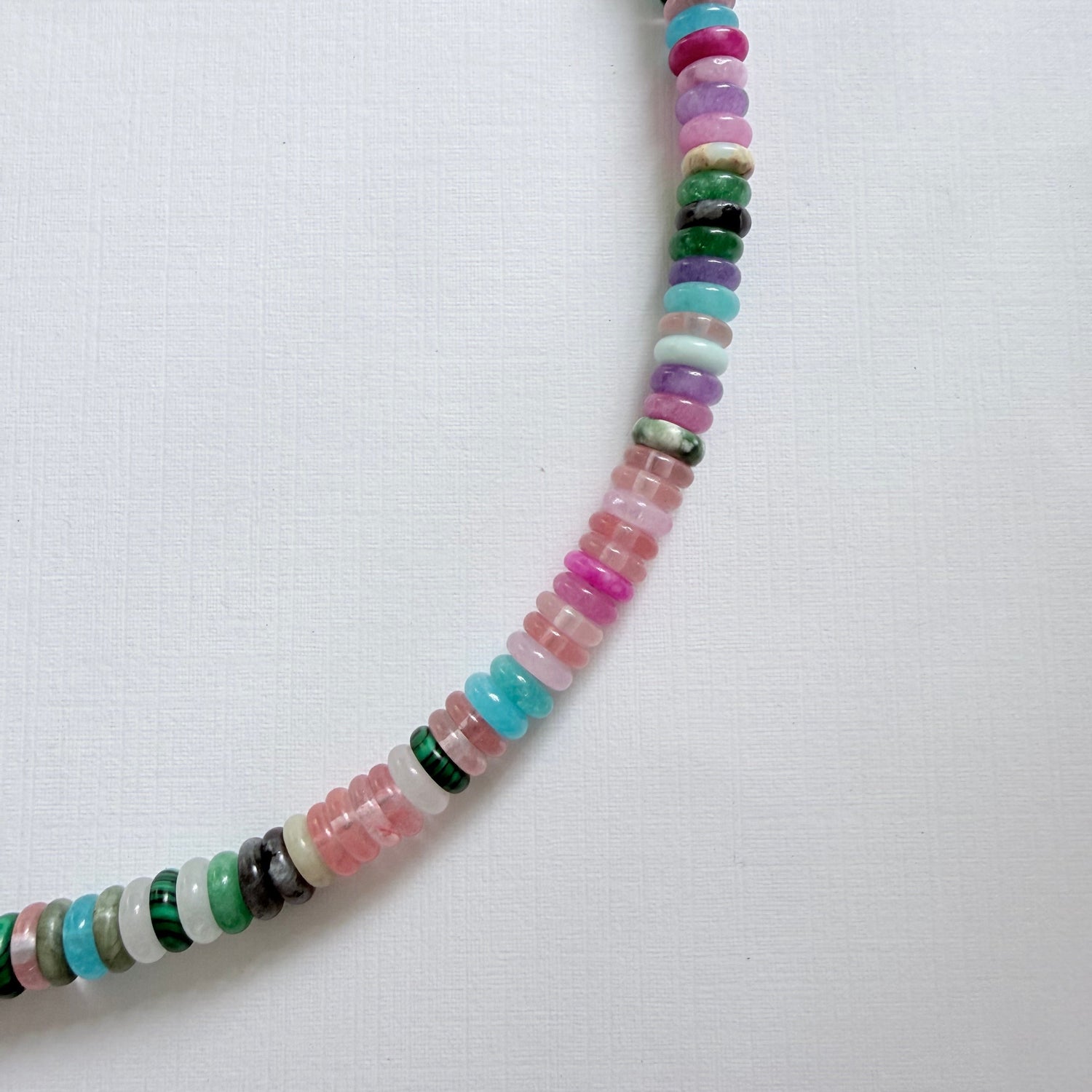 Colorful beaded necklace on a white background