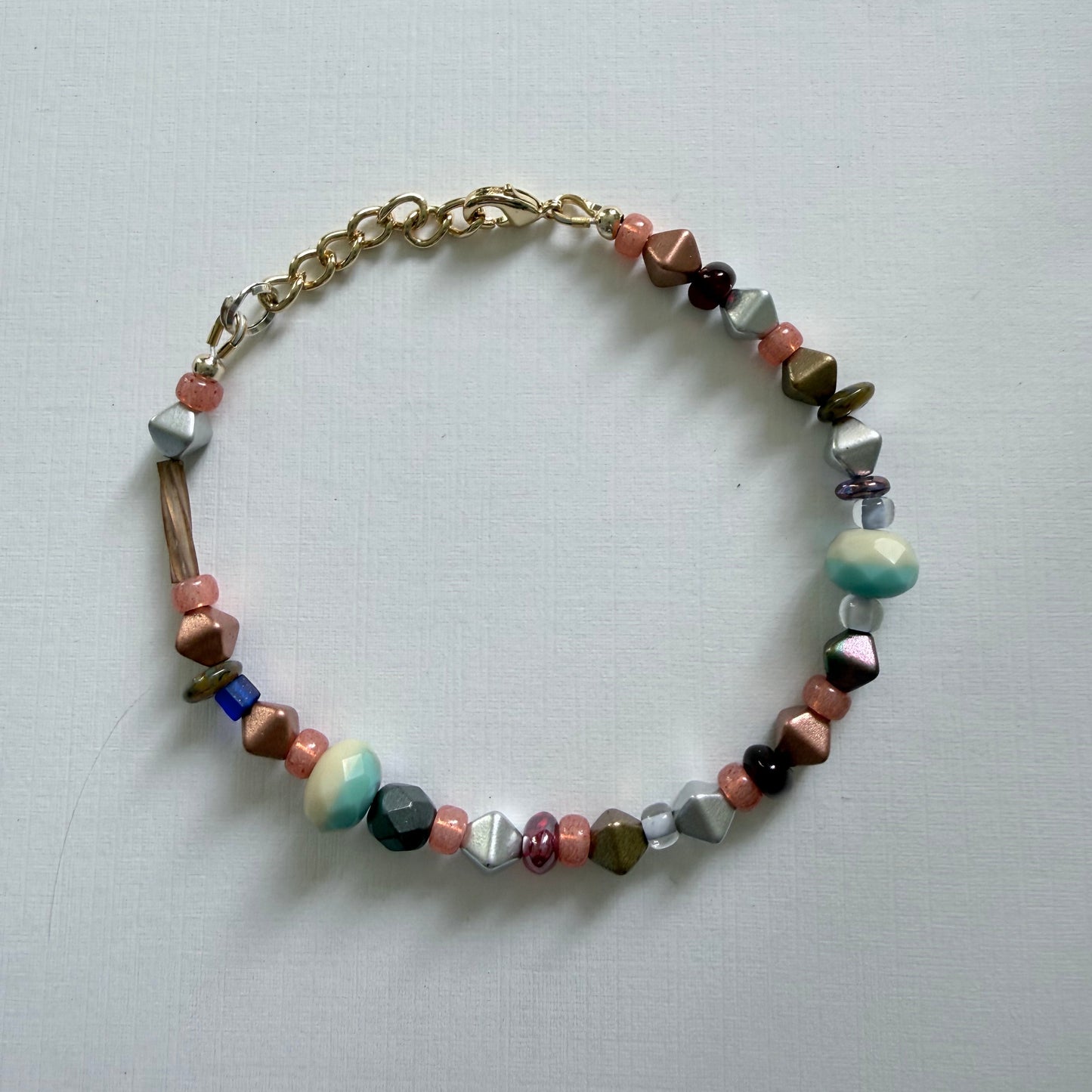 Multicolored beaded bracelet on a light gray background