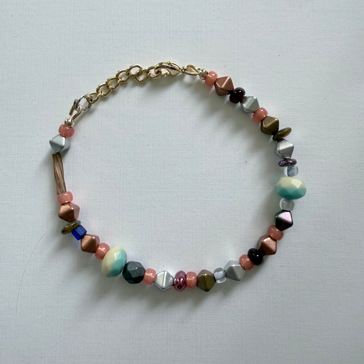 Multicolored beaded bracelet on a light gray background