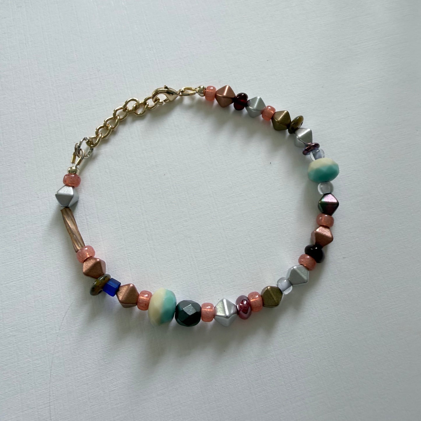 Multicolored beaded bracelet on a light gray background