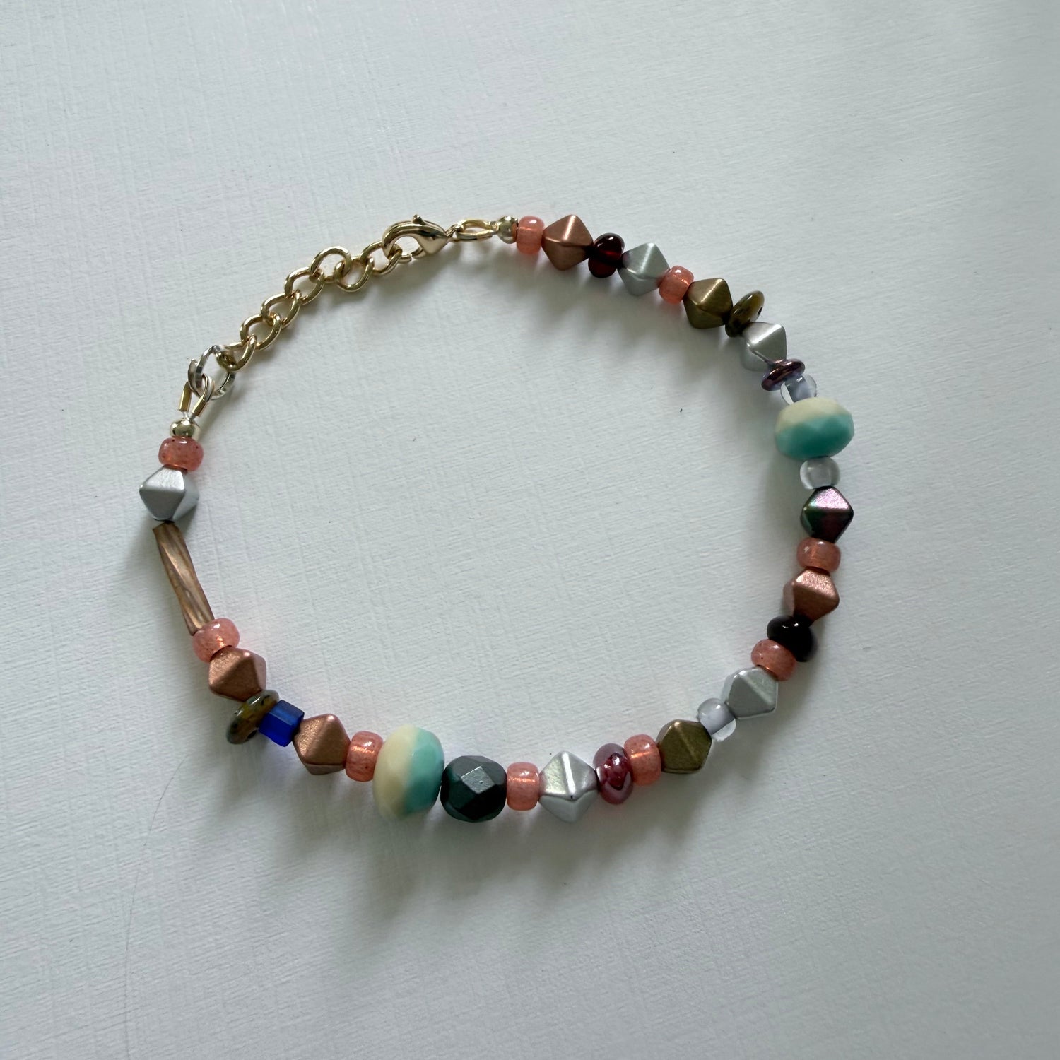 Multicolored beaded bracelet on a light gray background