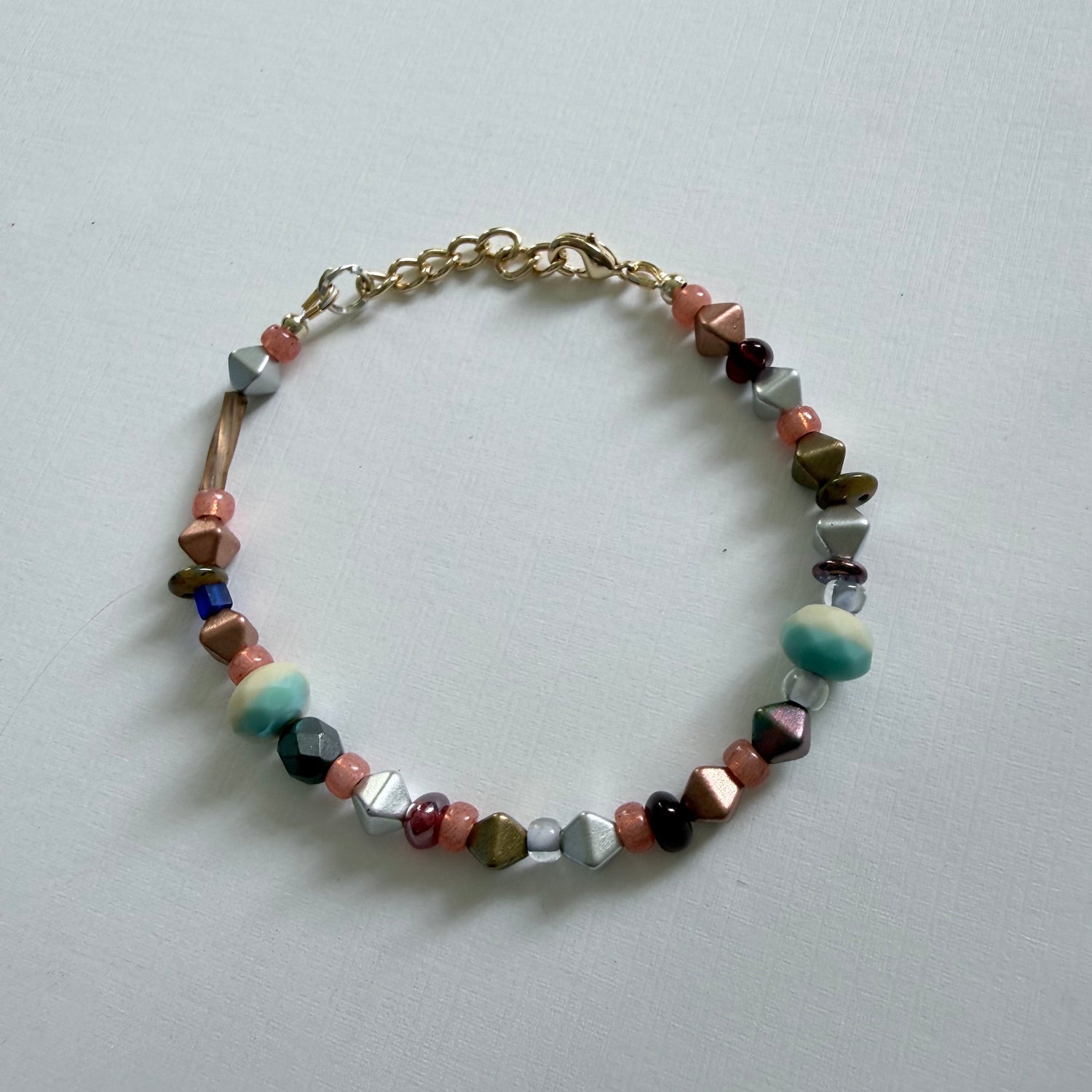 Multicolored beaded bracelet on a light gray background