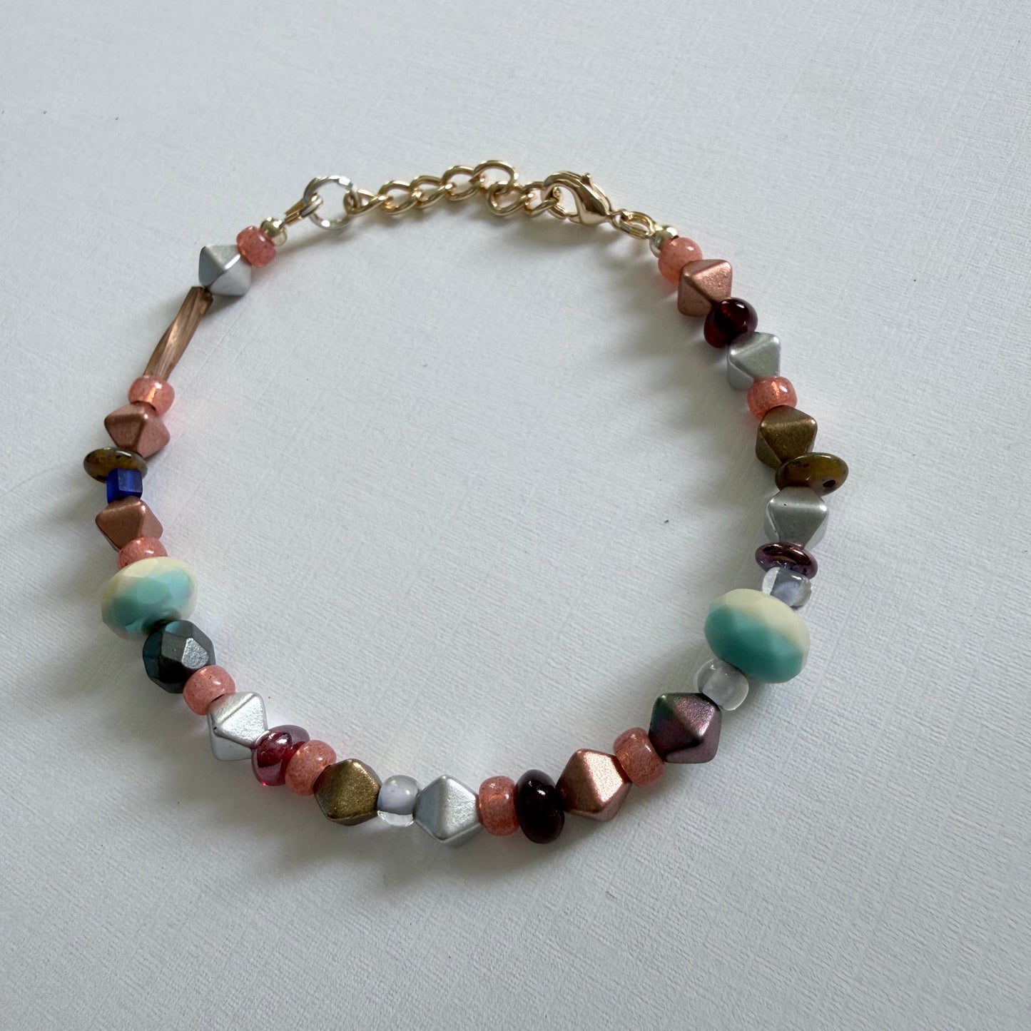 Multicolored beaded bracelet on a light gray background