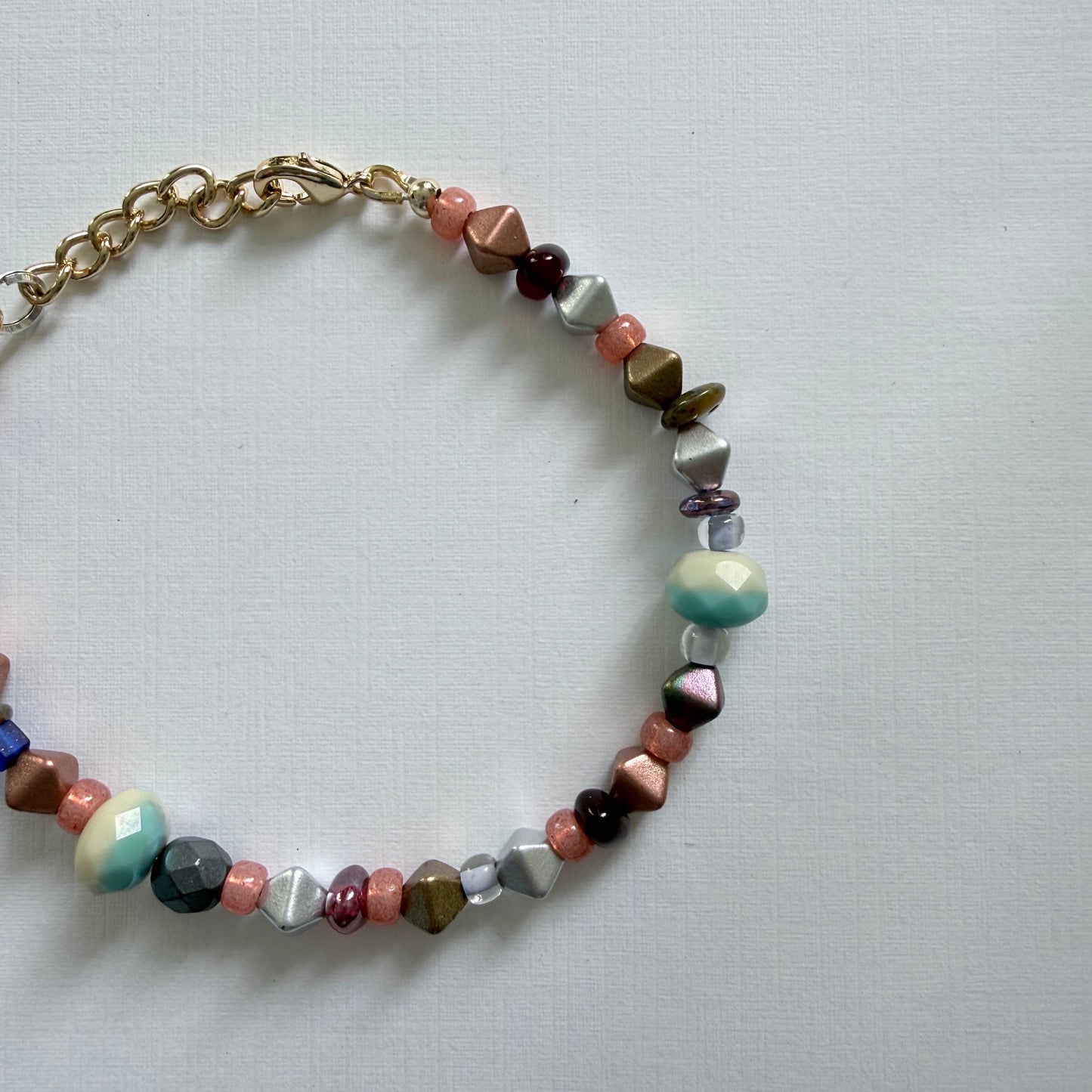 Multicolored beaded bracelet on a light gray background
