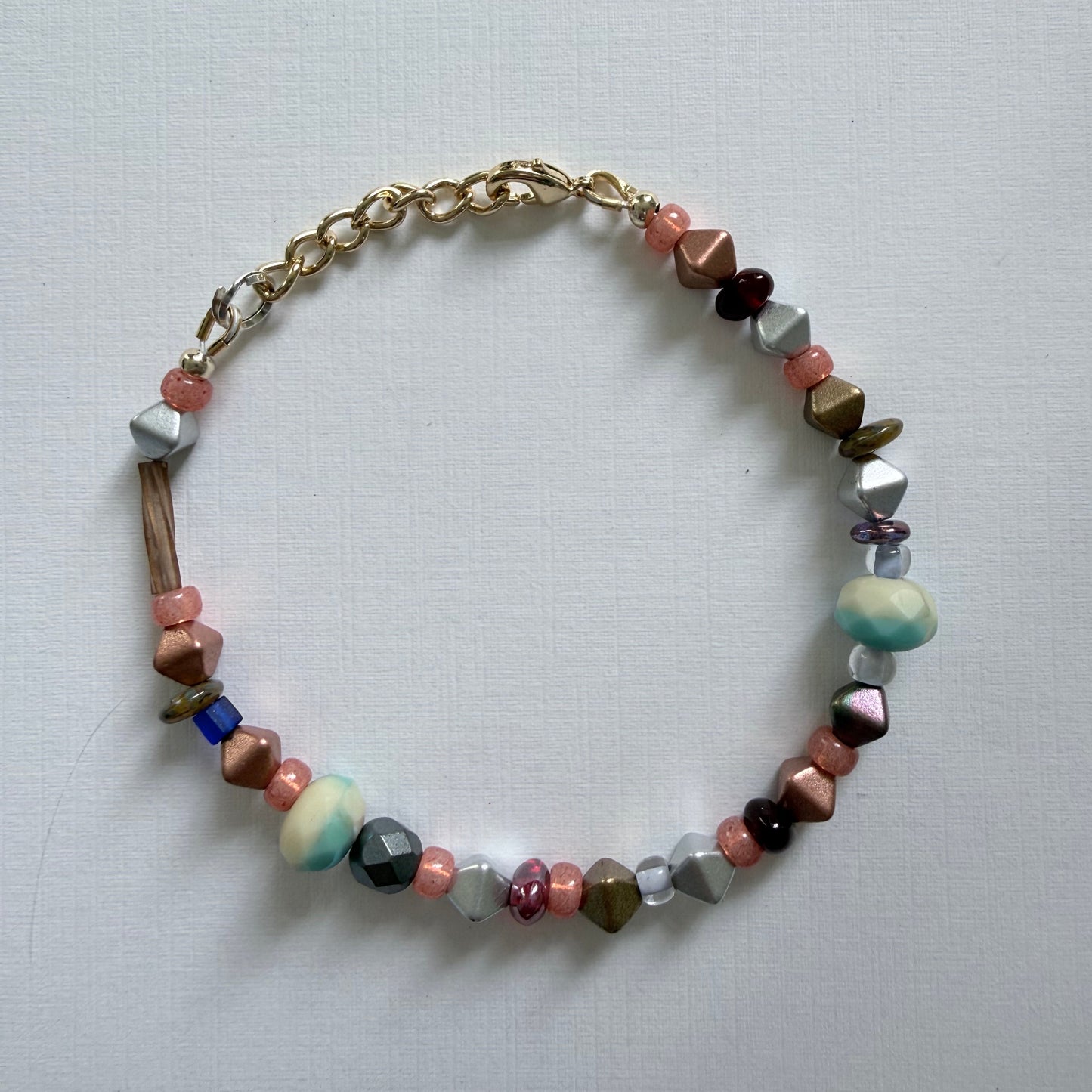 Multicolored beaded bracelet on a light gray background