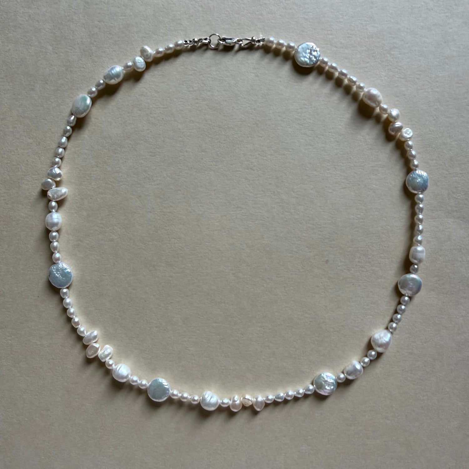 Pearl necklace on a beige background