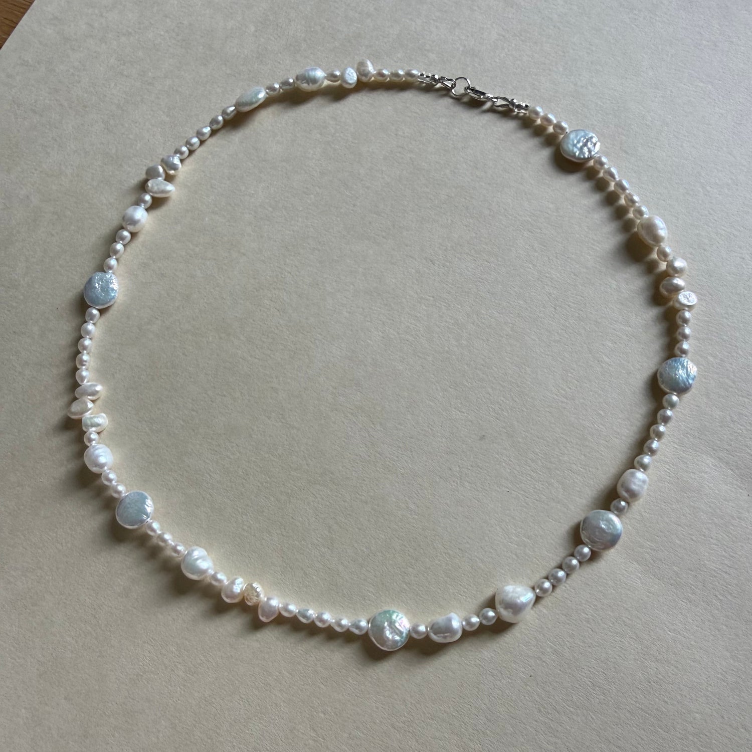 Pearl necklace on a beige background