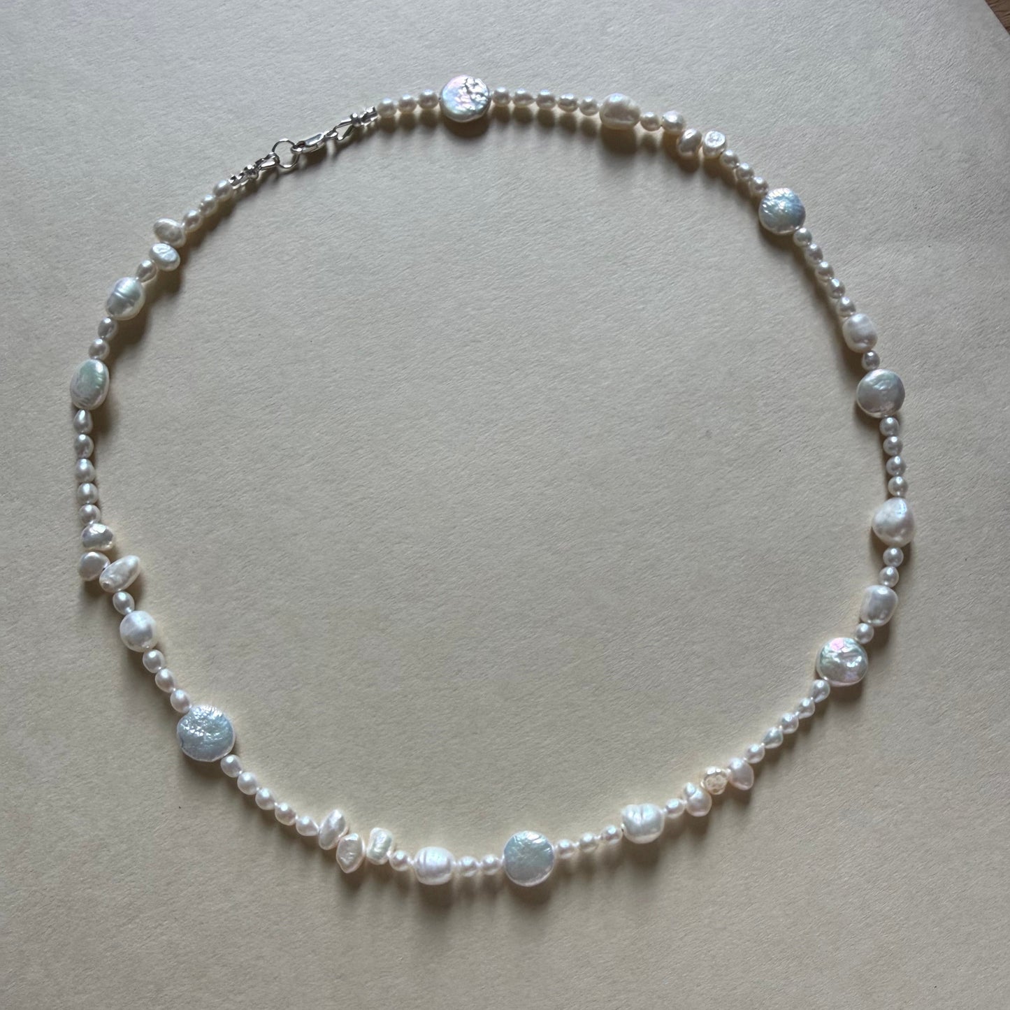 Pearl necklace on a beige background