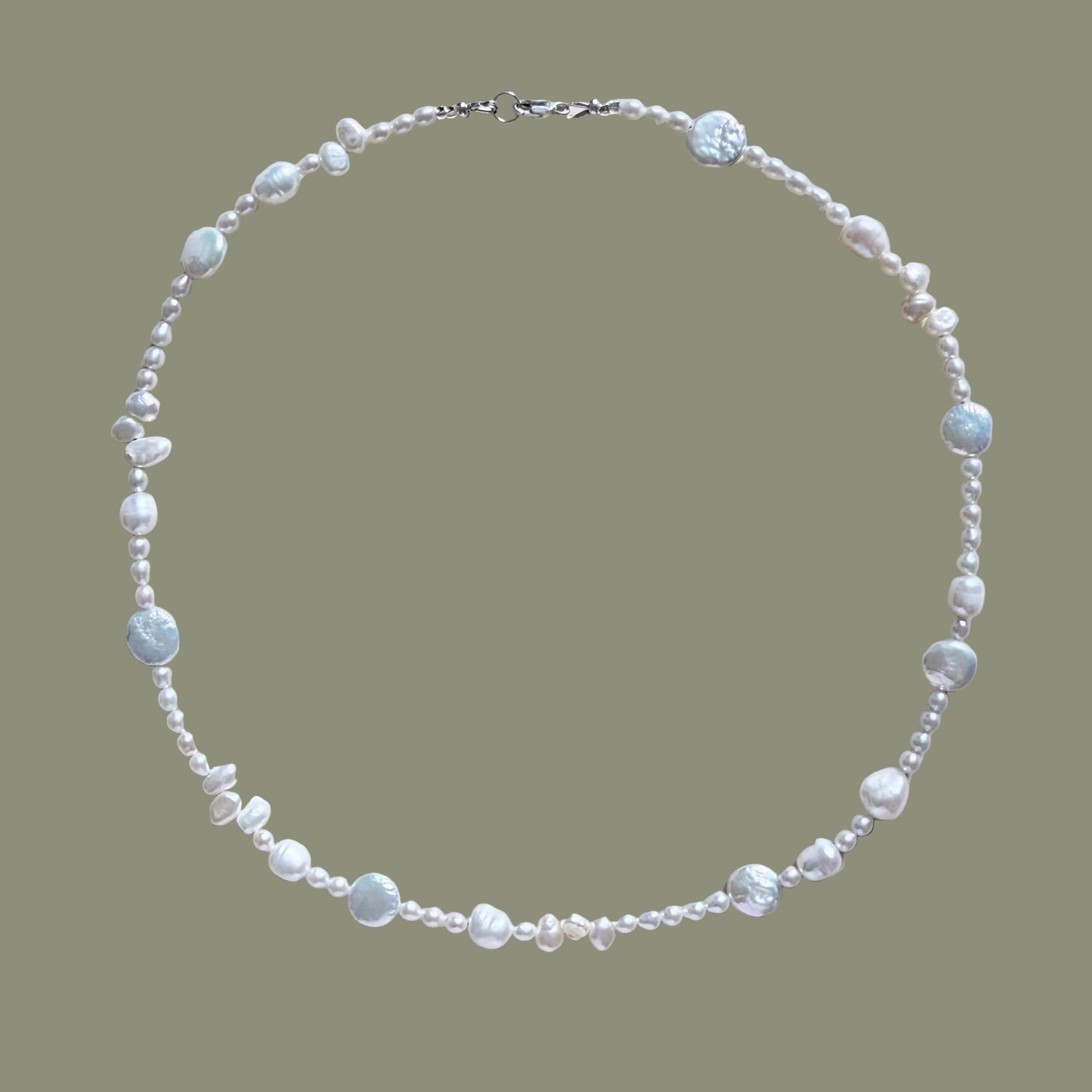 Pearl necklace on a light beige background