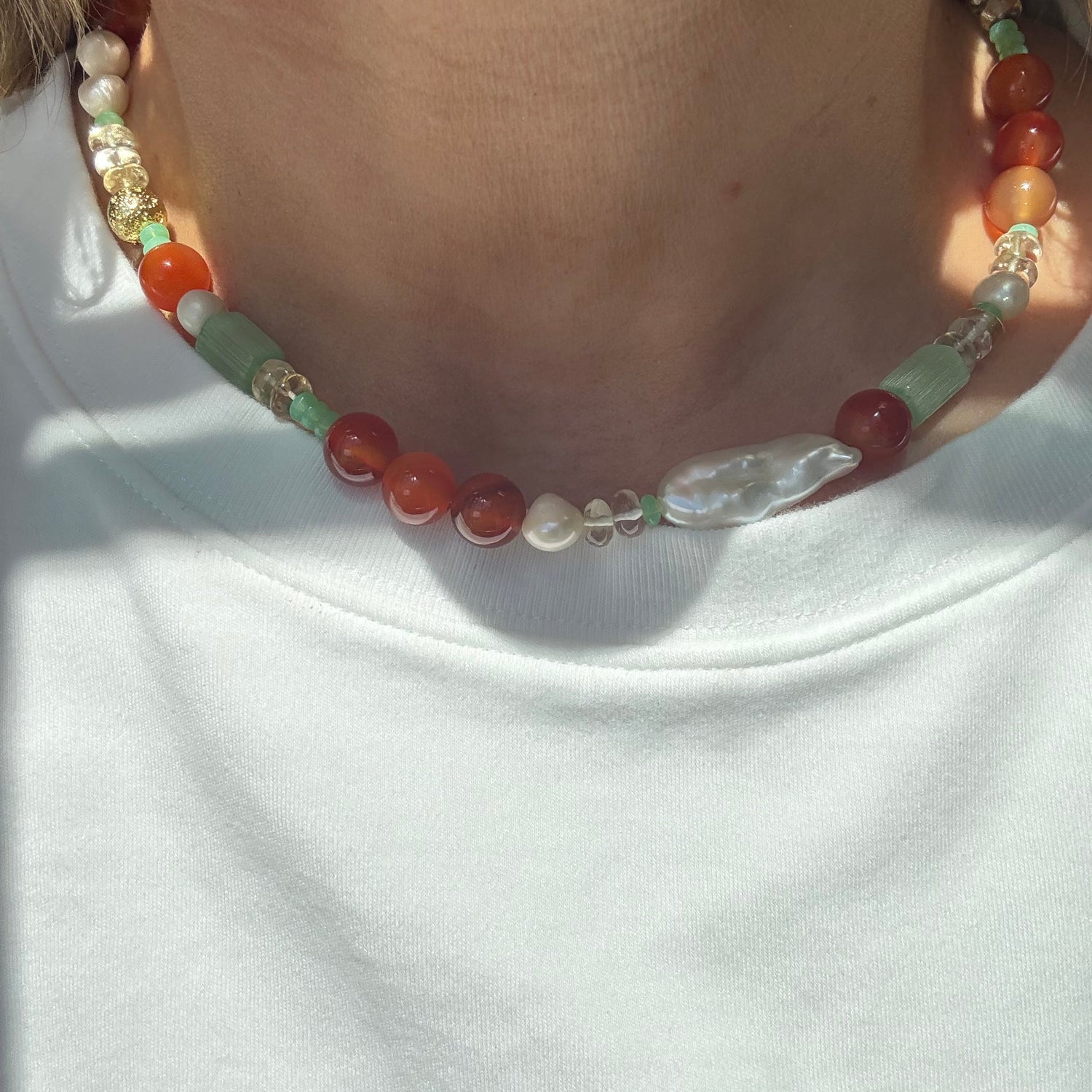 Beaded necklace with multicolored beads on a white background