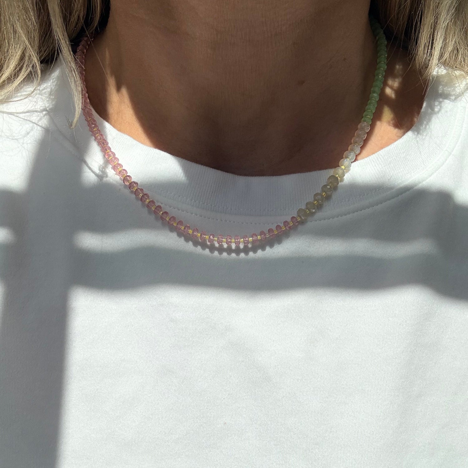 Close-up of a person wearing a beaded headband on a white background