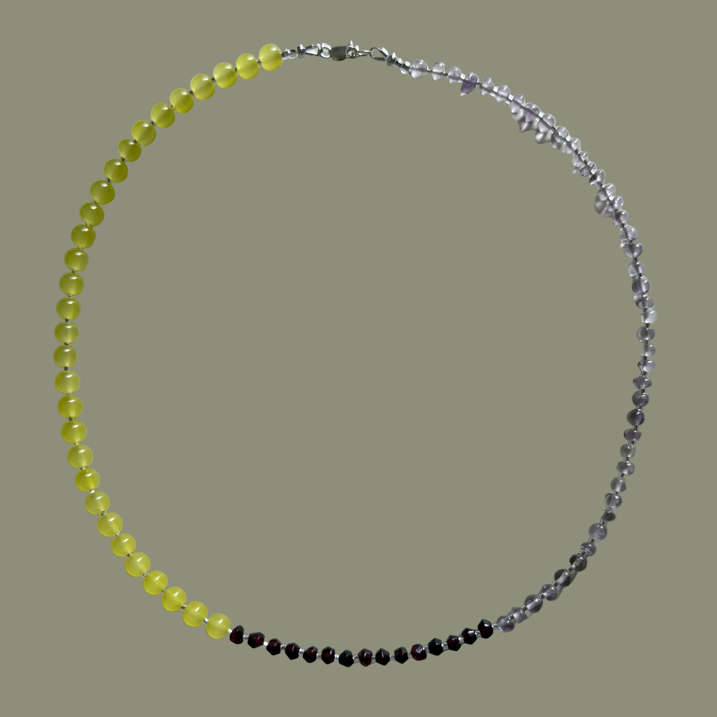 Beaded necklace with yellow, black, and clear beads on a white background