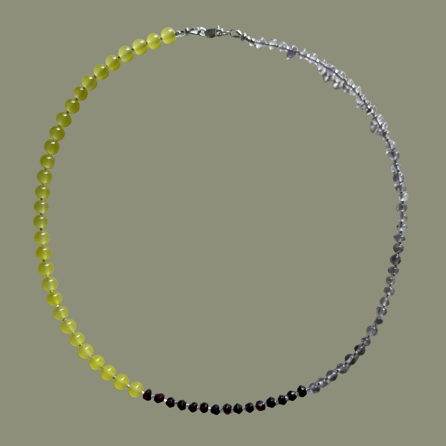 Beaded necklace with yellow, black, and clear beads on a white background